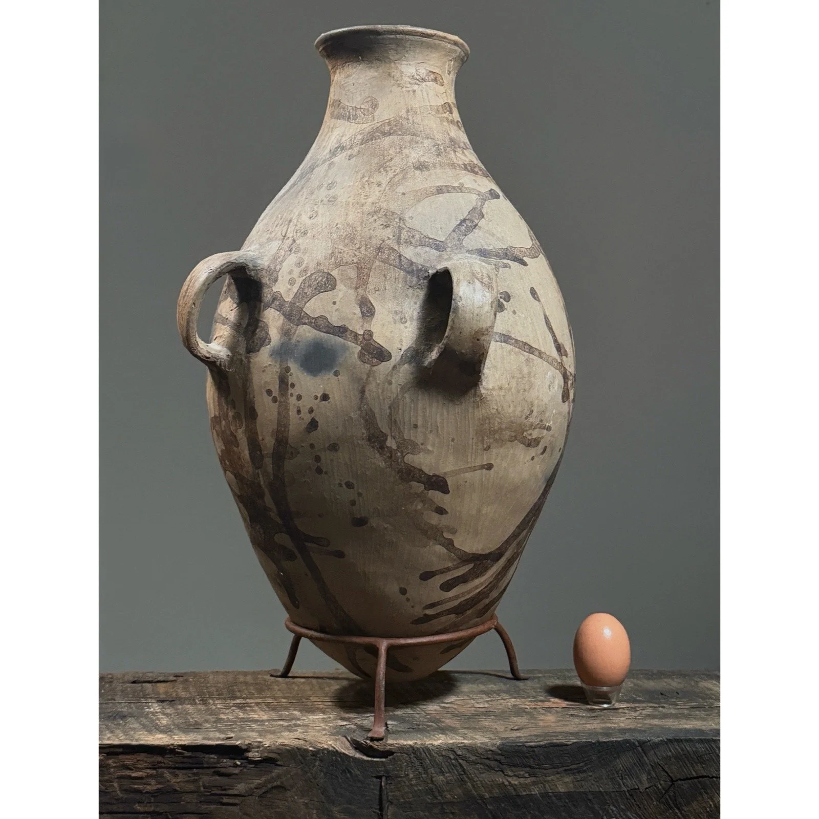 Oaxacan amphora pottery with twin handles and tapered neck with egg for size reference.