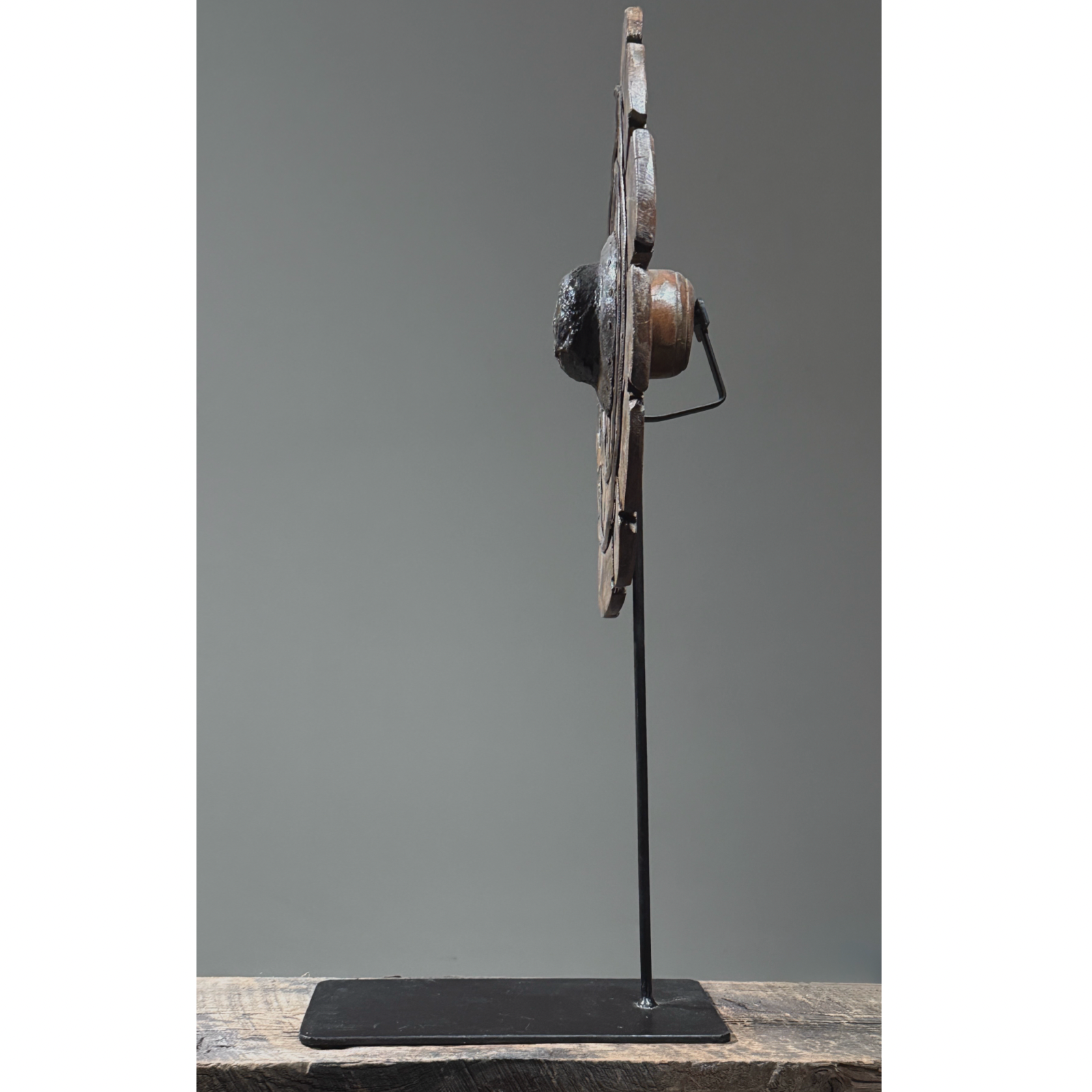 Side profile of antique hand carved folk art charkha wheel. Traditional Indian spinning wheel. 27 inches high.