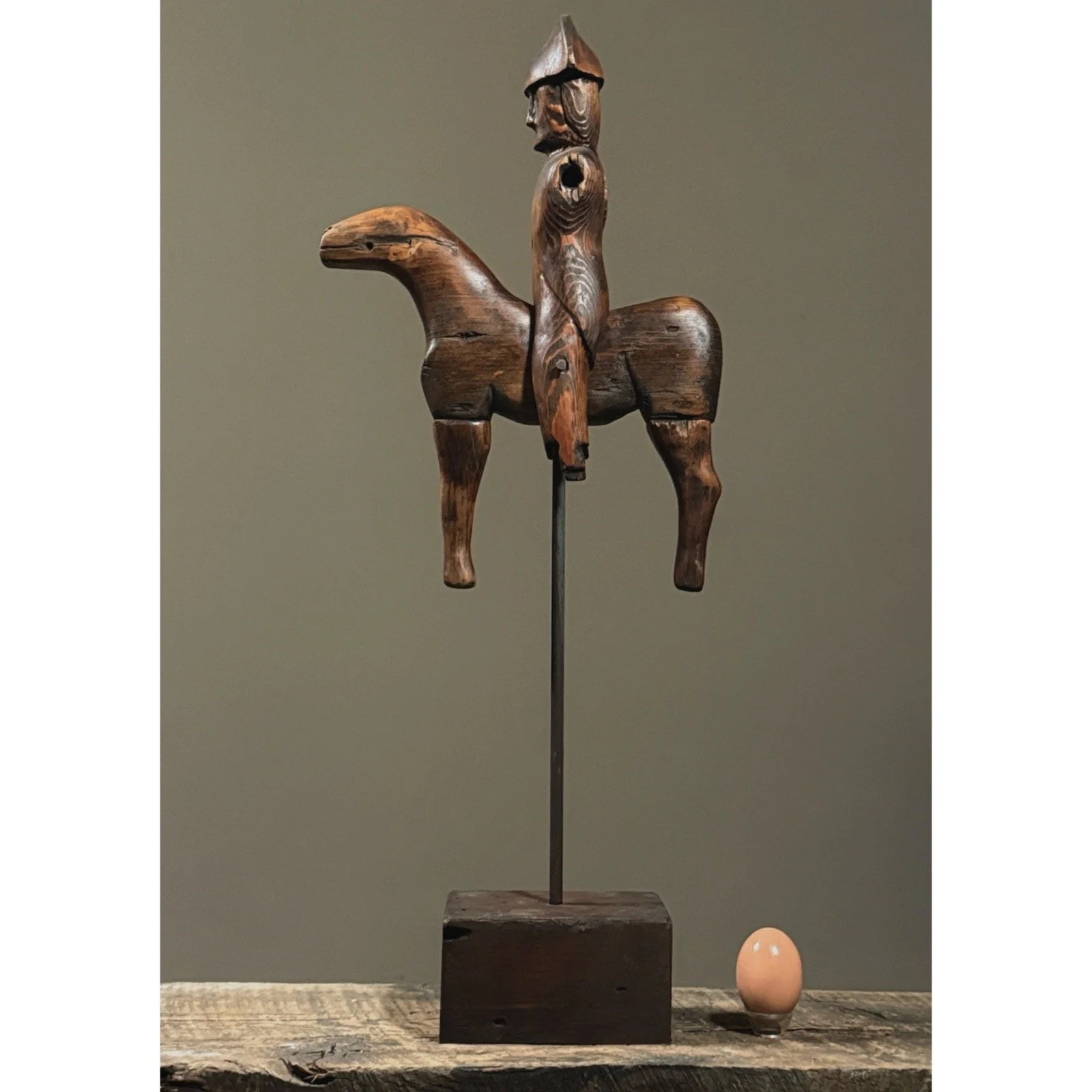 Vintage folk art hand-carved soldier on horse sculpture, with egg for size reference. .