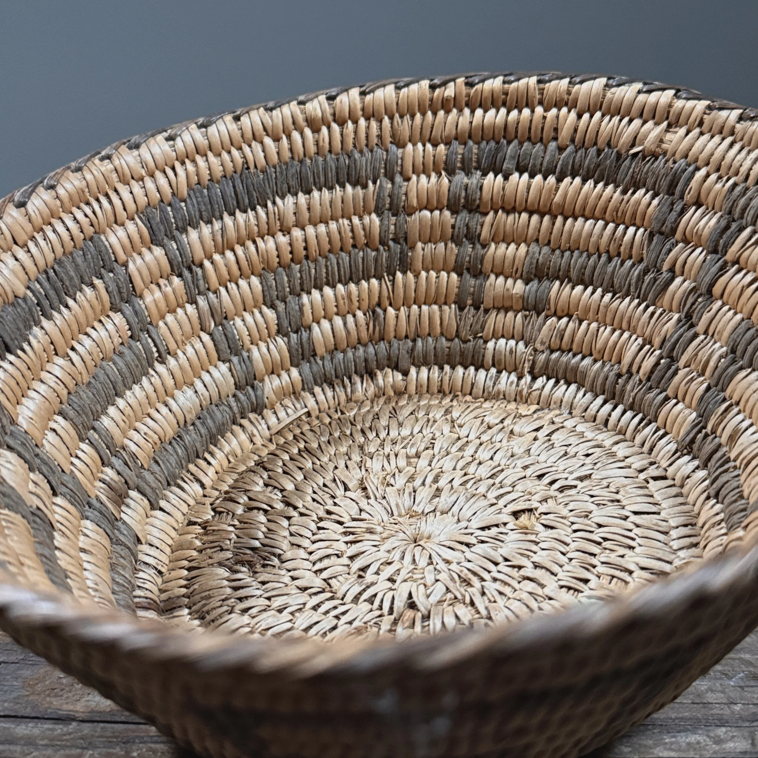 Interior of basket. Smooth woven surface. Unadorned inner wall.