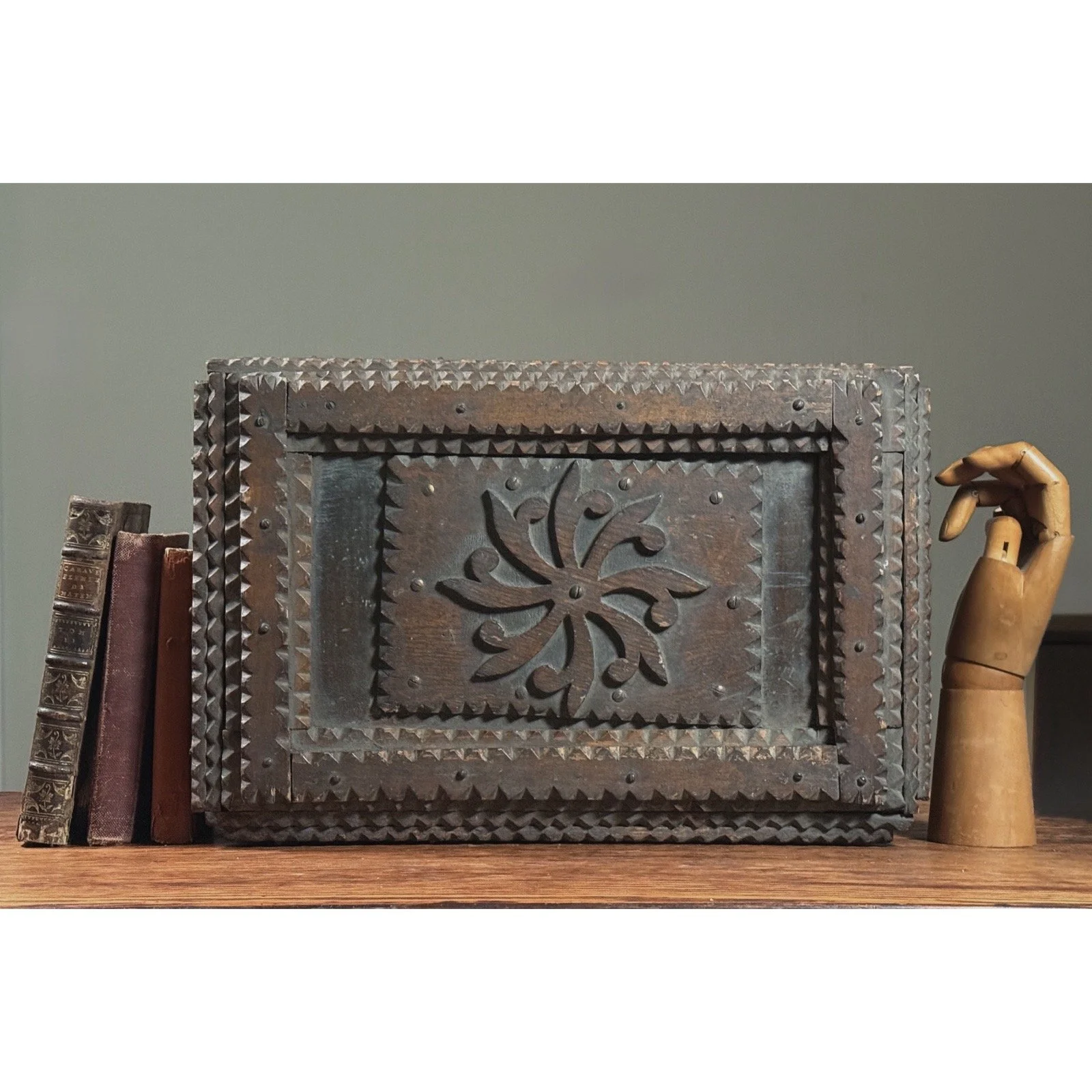 The tramp art chest shown with a common objects for scale.