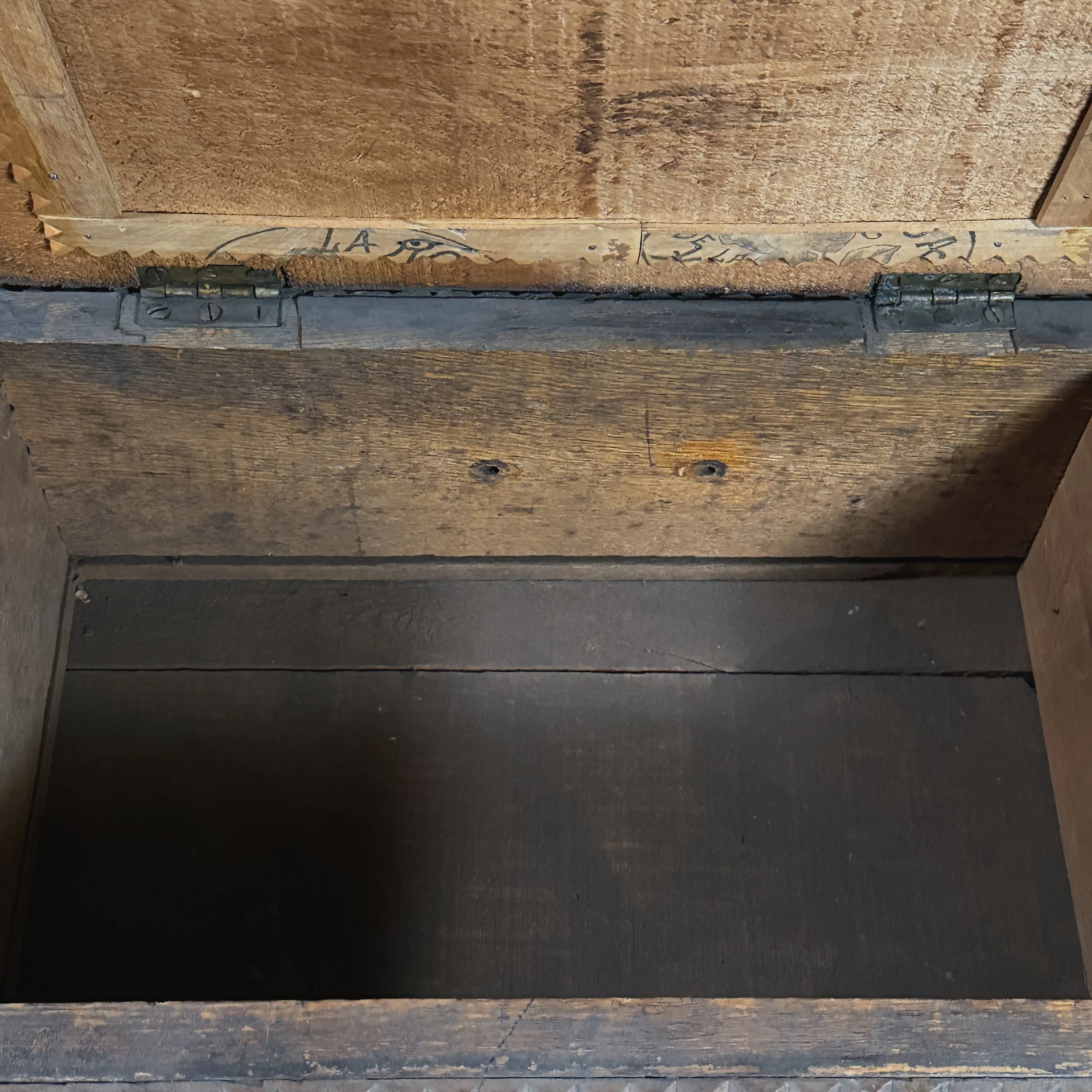 View of the chest's interior, showing its unfinished storage space.
