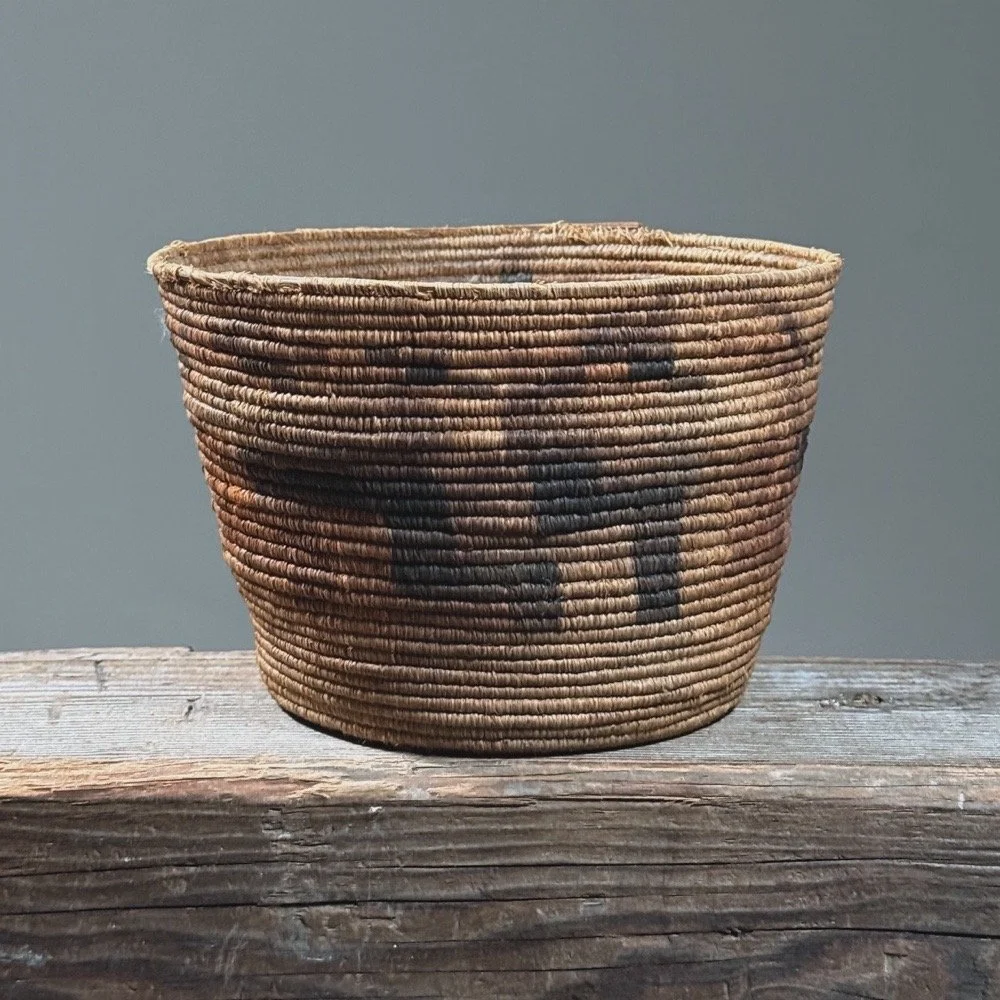 Full frontal view of an antique Tohono O'odham coiled basket with geometric step pattern