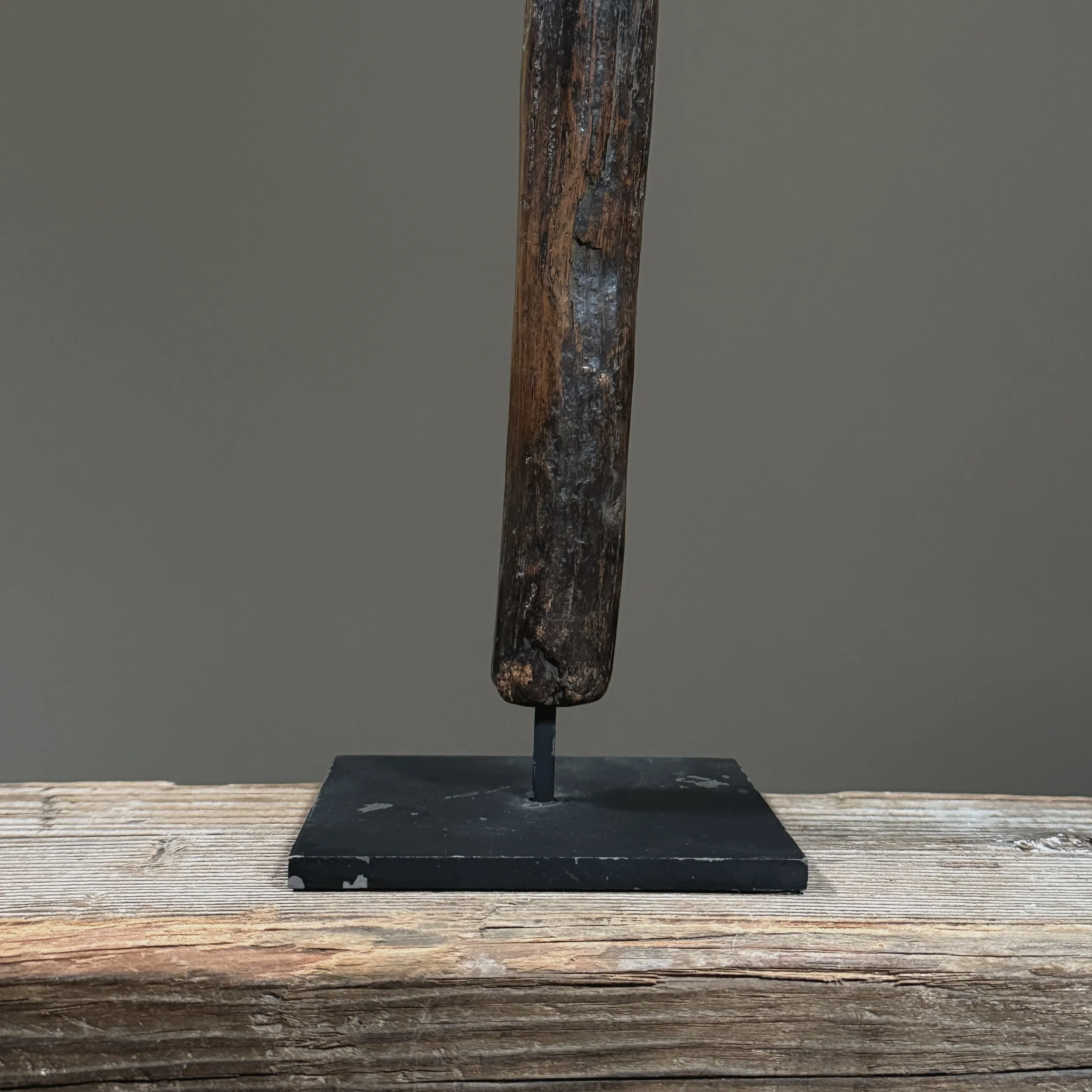 The scepter displayed on its custom black metal museum mount, isolated against a neutral background.