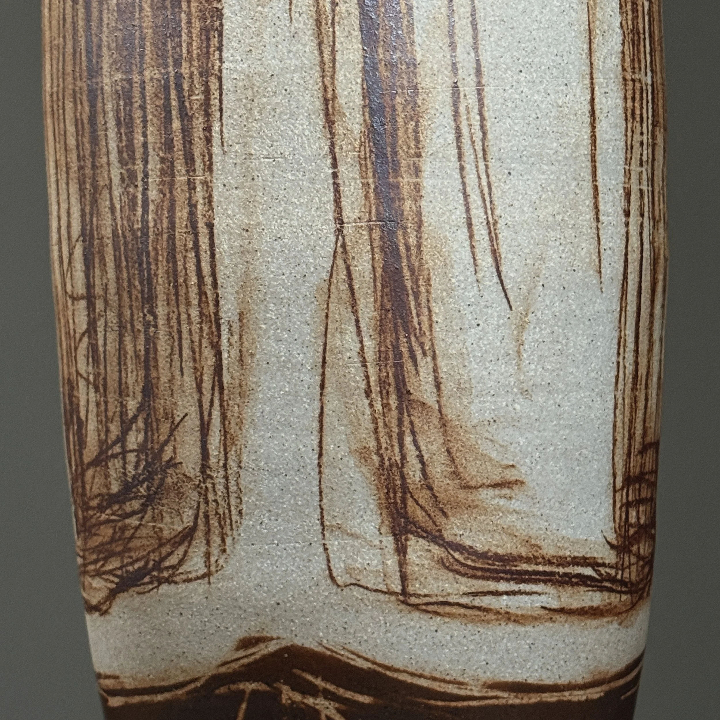 Sculptural tall ceramic vessel with artistic detailing