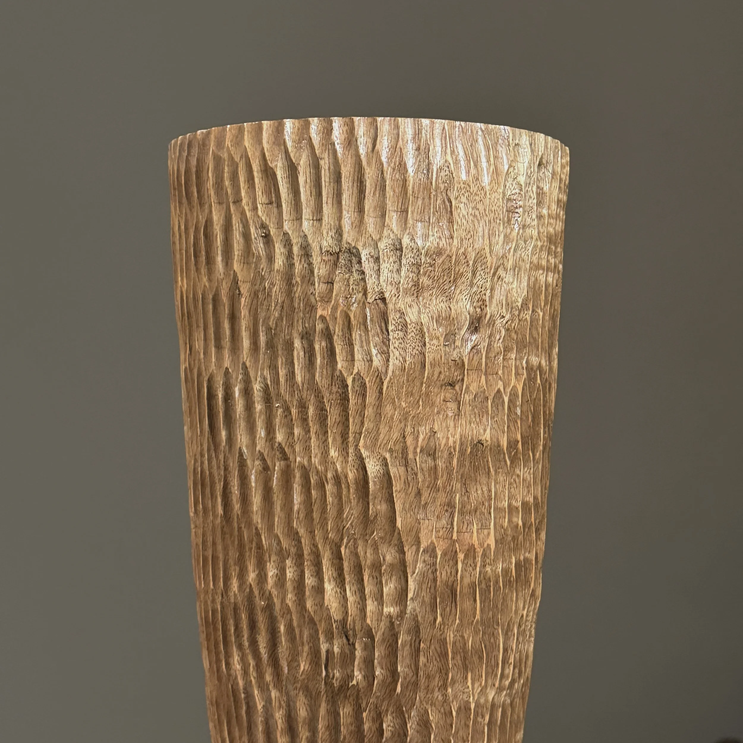 Detail of the chip-carved geometric pattern on the surface.