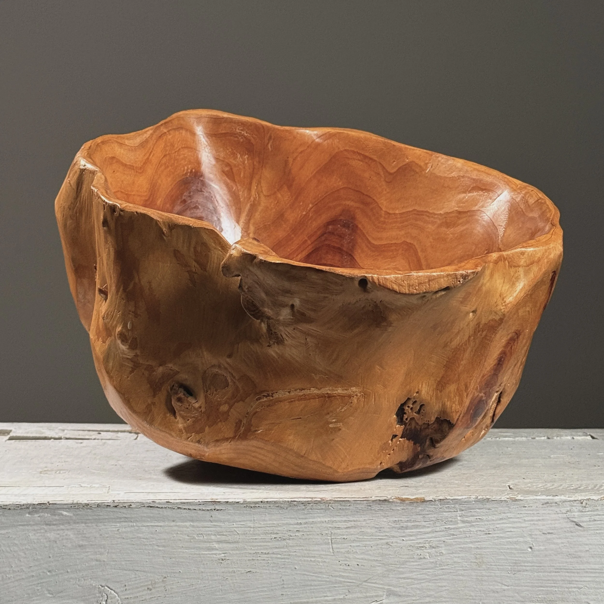 Full frontal view of a vintage hand-carved modernist root bowl with live edge exterior