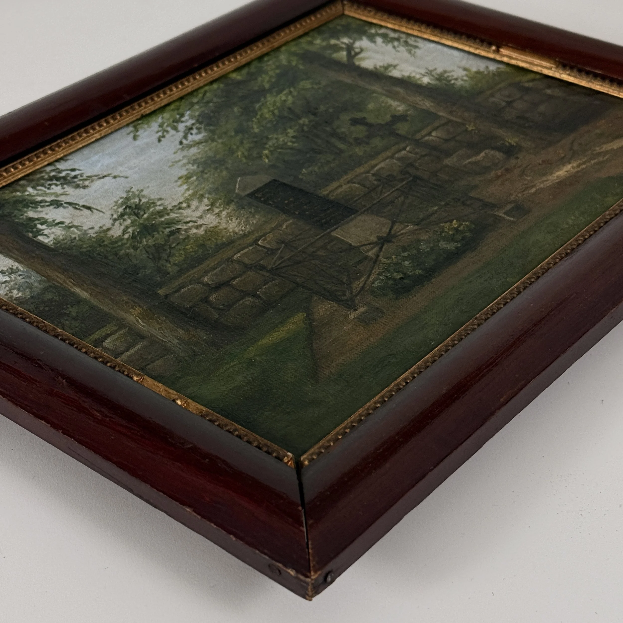 Three-quarter view of 1907 Danish Folk Art cemetery study showing canvas and mahogany frame with gilt trim together