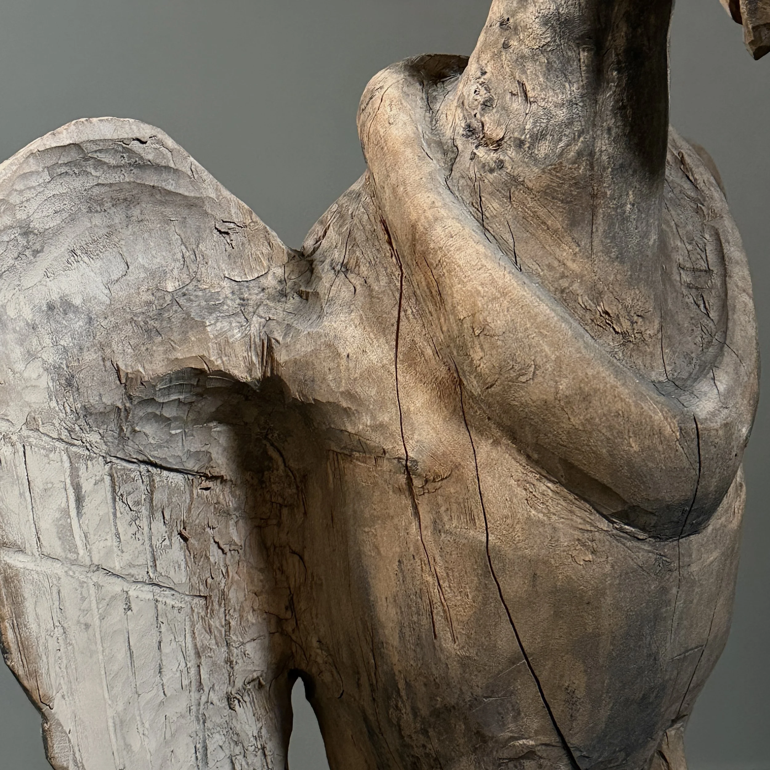 Rustic hand carved bird sculpture aged wood surface