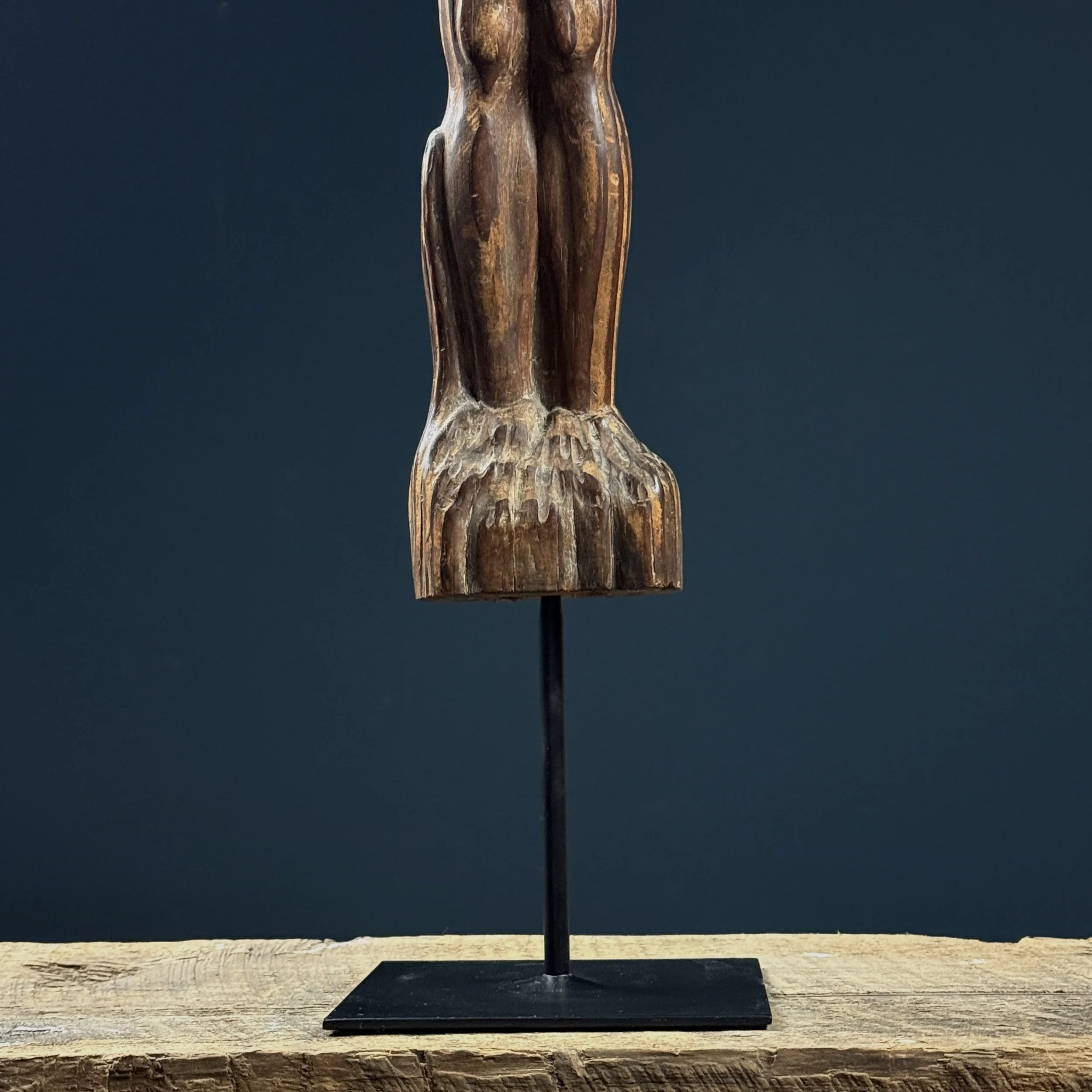 Detail of the custom black metal stand and mounting.