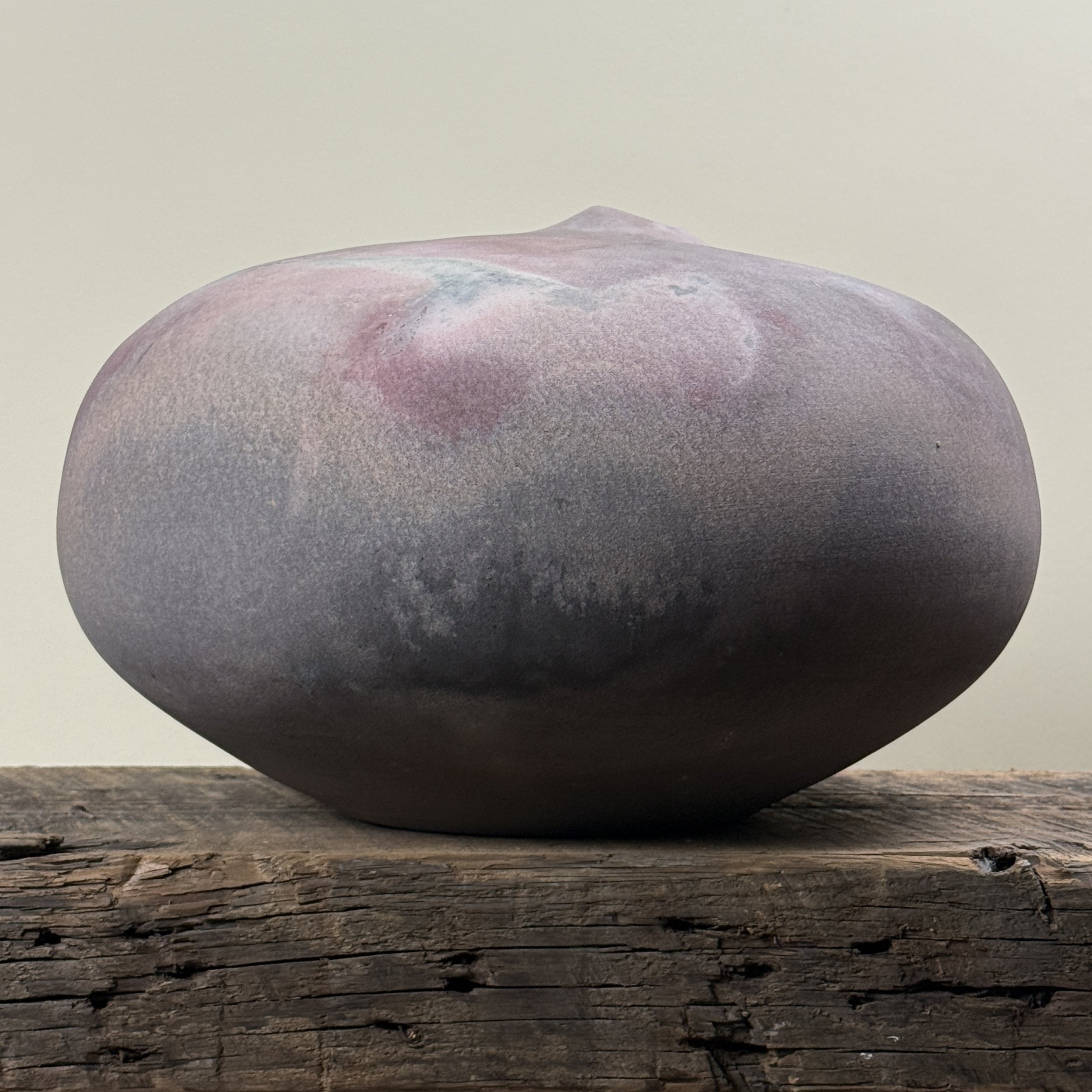 Jeffrey Zigulis large anagama fired seed pot vessel. Muted mauve and magenta hues. 12.5 inches diameter.