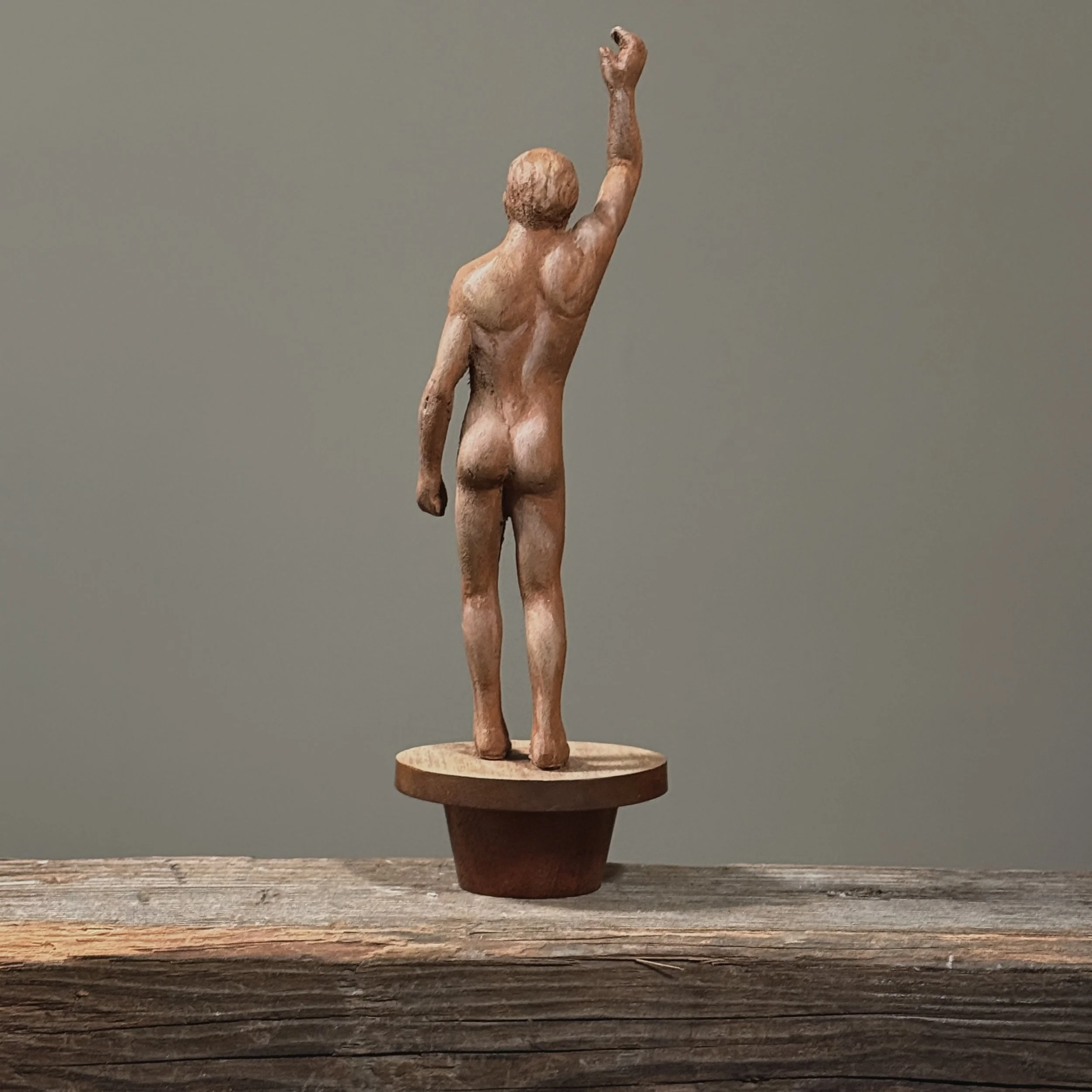 Vintage folk art sculpture with tapered wooden stand Back view.