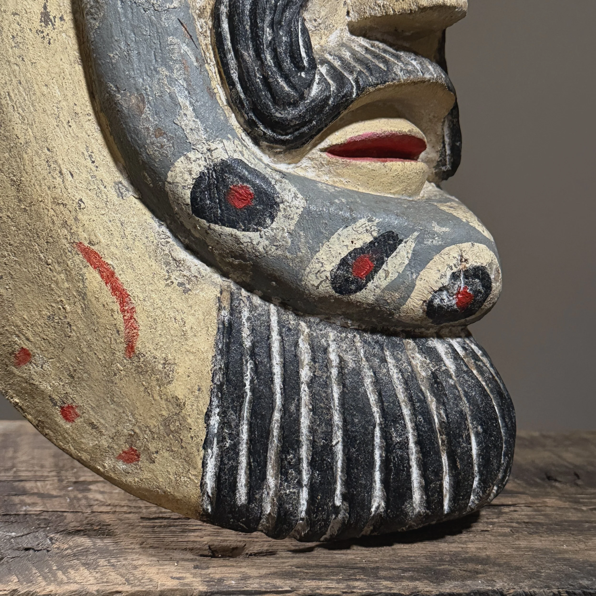 Close-up of the face showing polychrome paint and areas of loss.