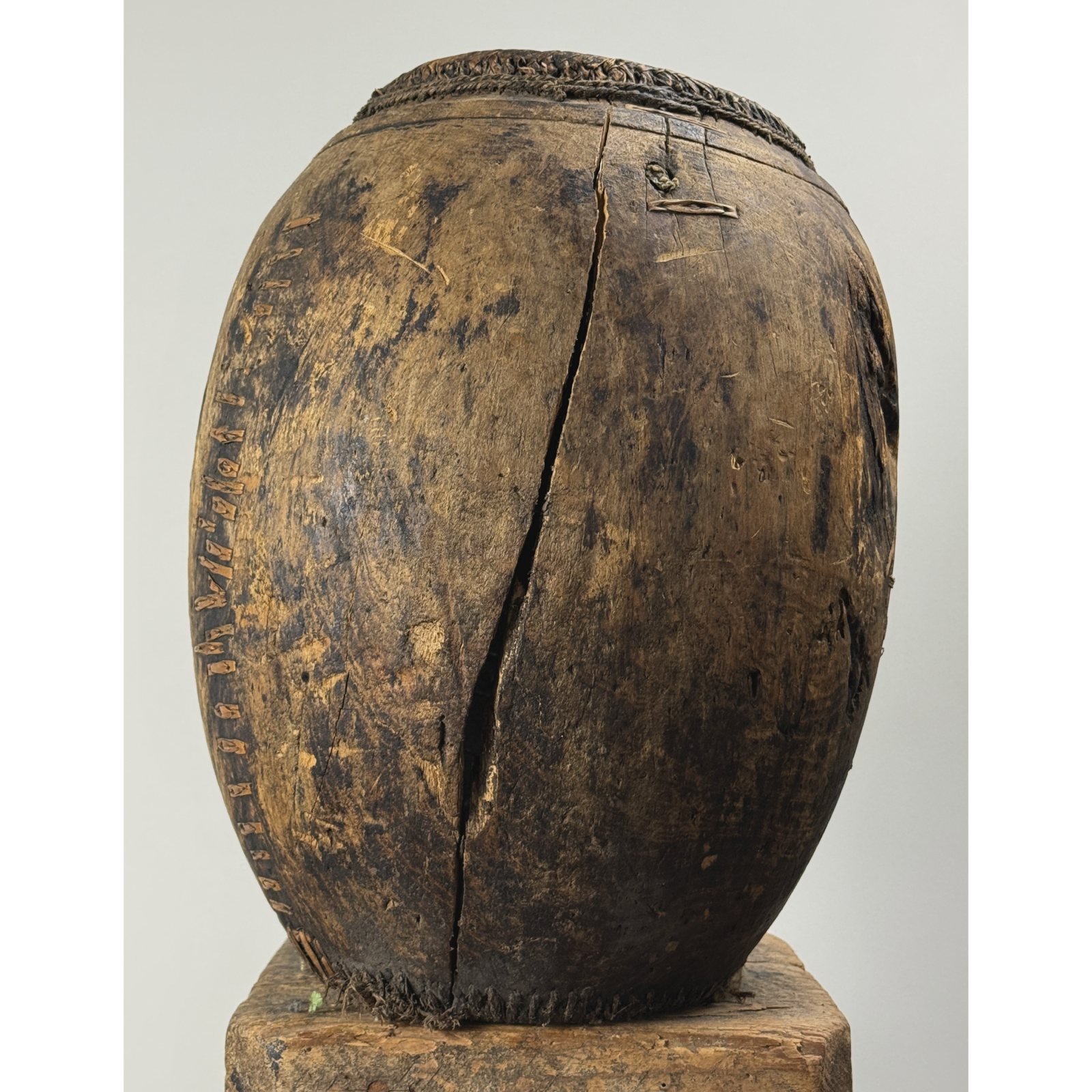 Antique hand carved wooden vessel with woven detail, 15 inches high.