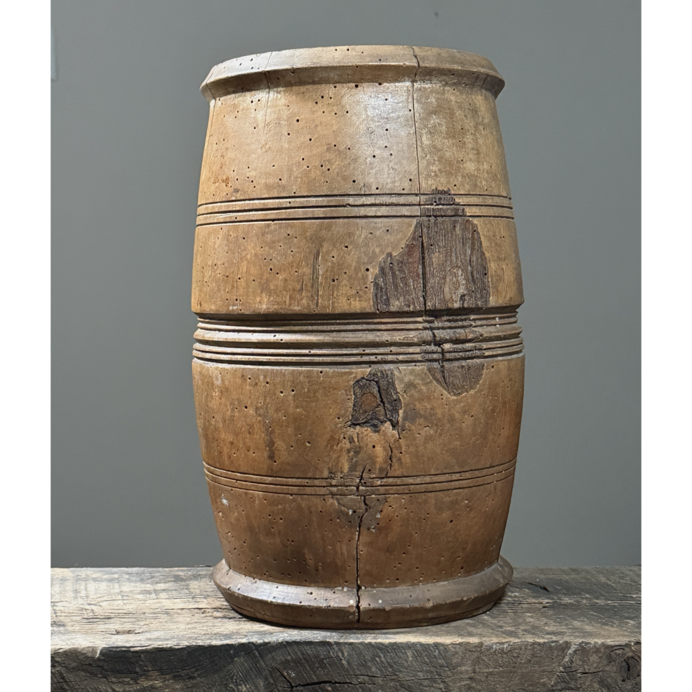 Front view of antique treenware barrel with concentric ribbed bands