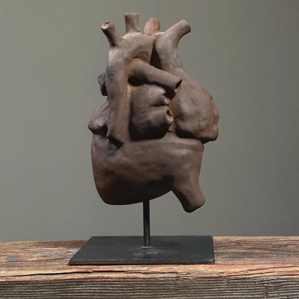 Vintage Surrealist hand-built clay heart sculpture on black stand