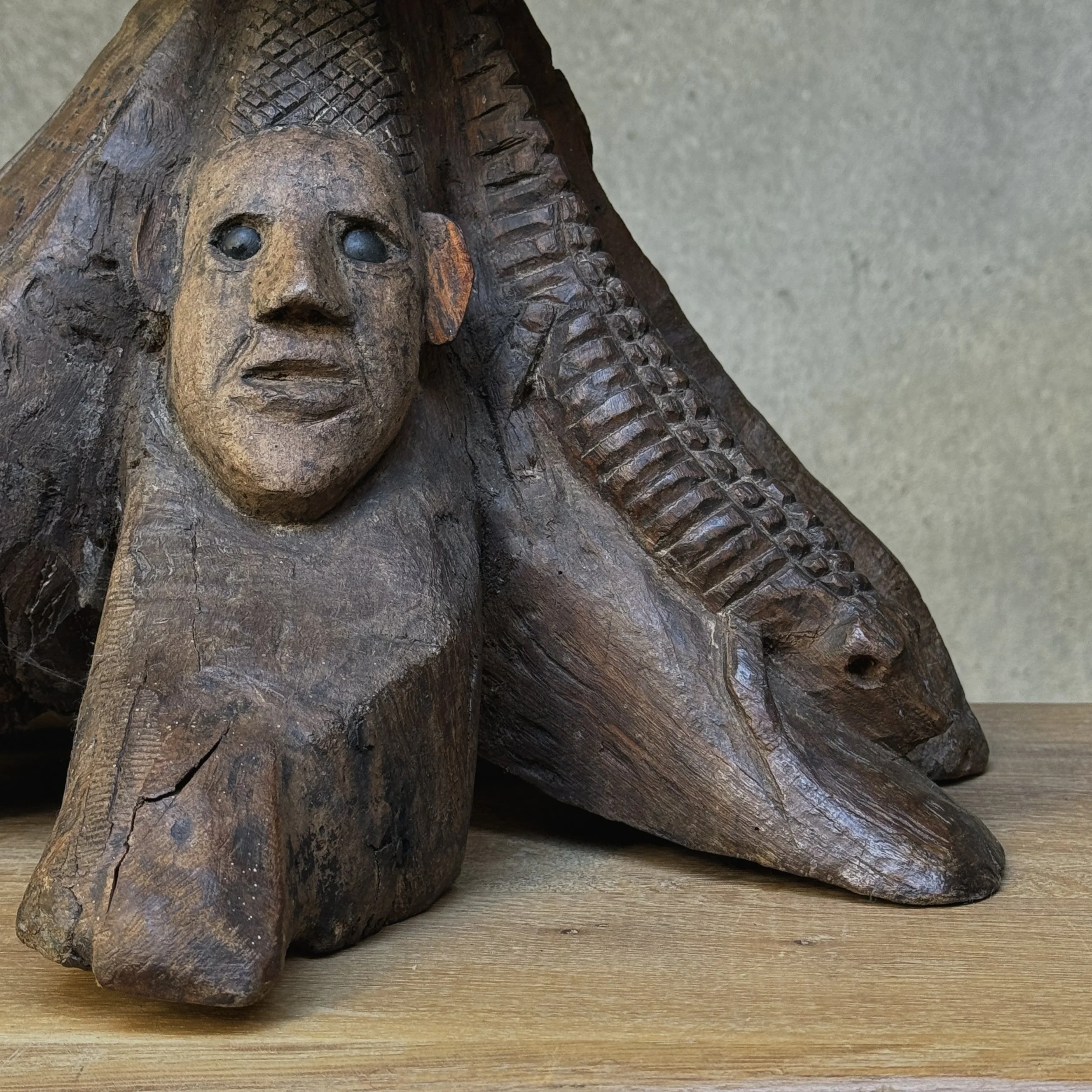 Folk art sculpture with carved face underneath