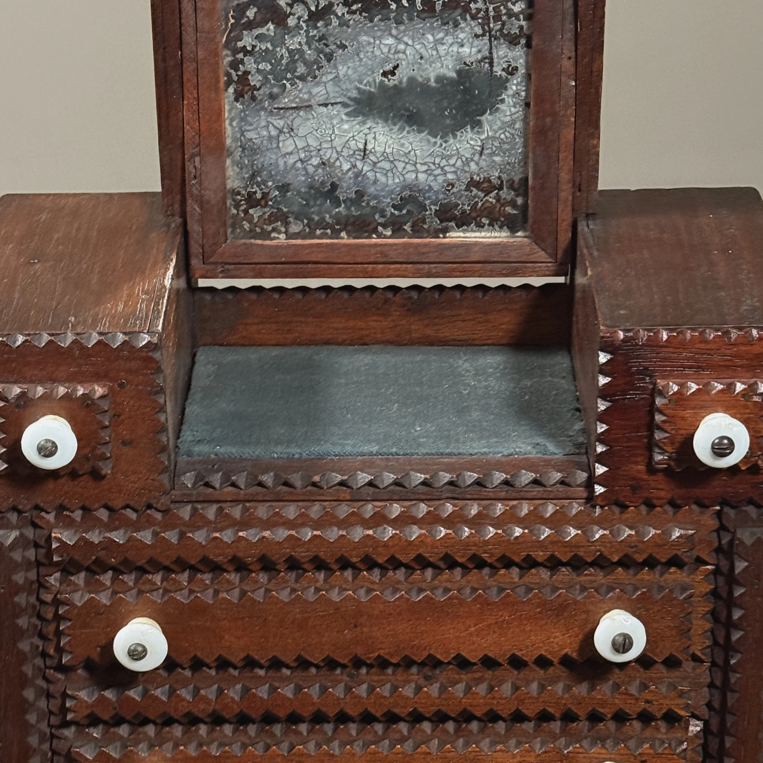 Close-up of the patinated, hinged mirror in its upright position