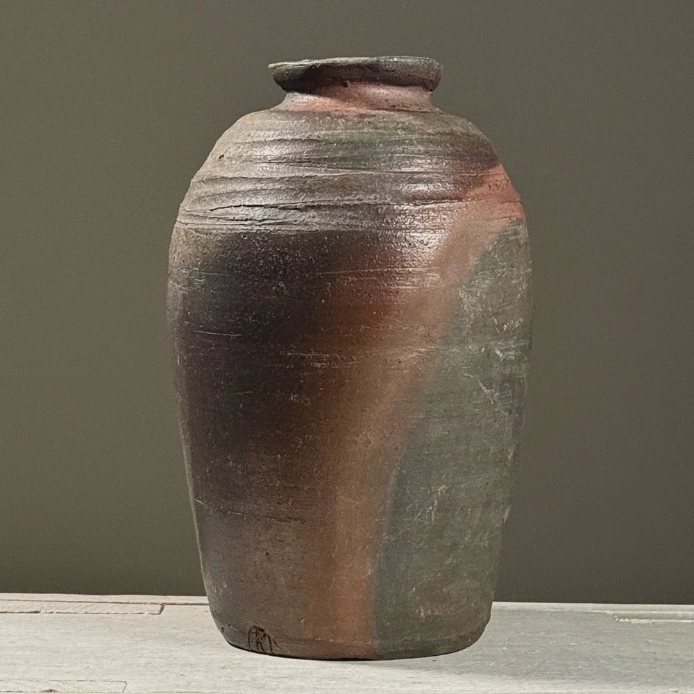Front view of a vintage wabi-sabi wood-fired stoneware vessel.