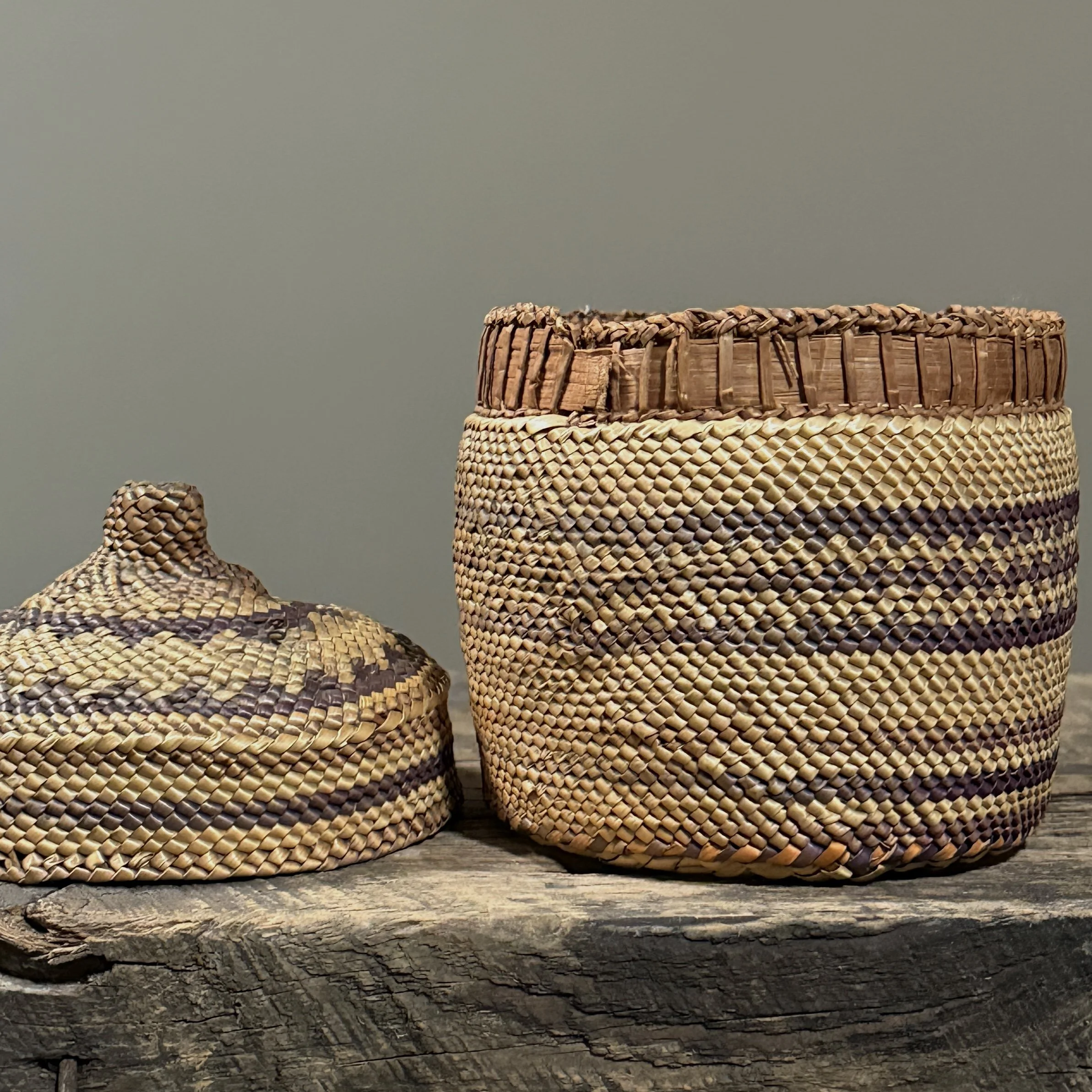 Close-up detail of wrapped twining technique and purple-dyed grass on an antique Makah basket