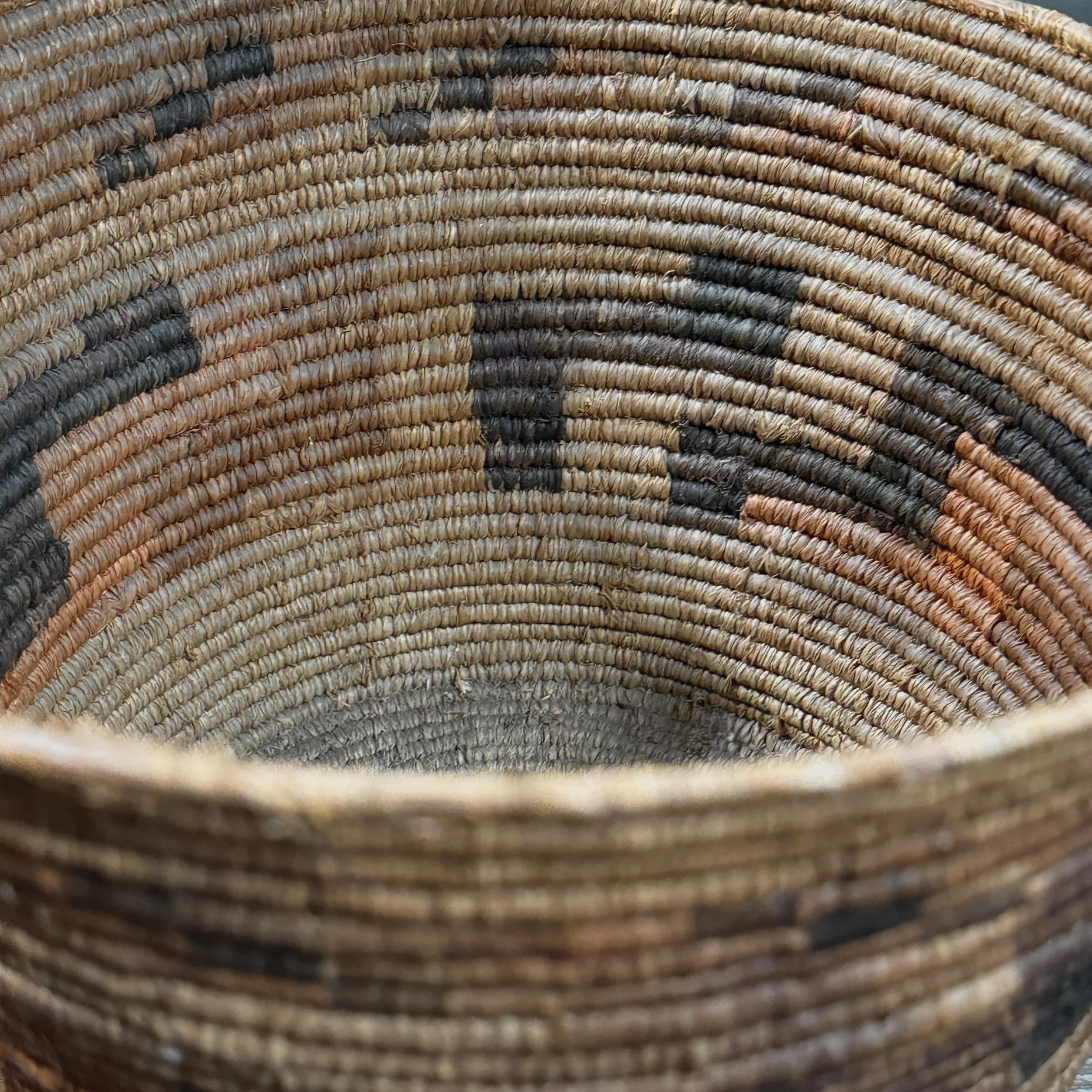 Close-up detail of the step pattern executed in dark devil's claw against a light yucca background