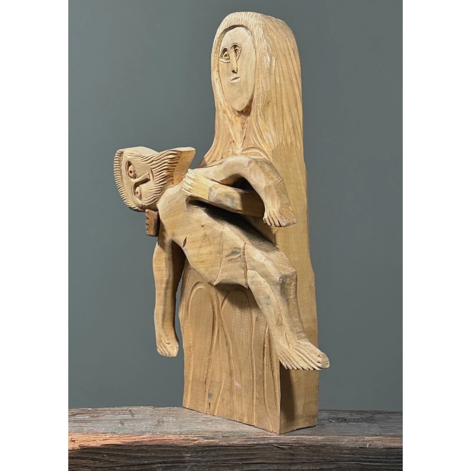 Profile view showing the shallow relief depth of the sculpture.