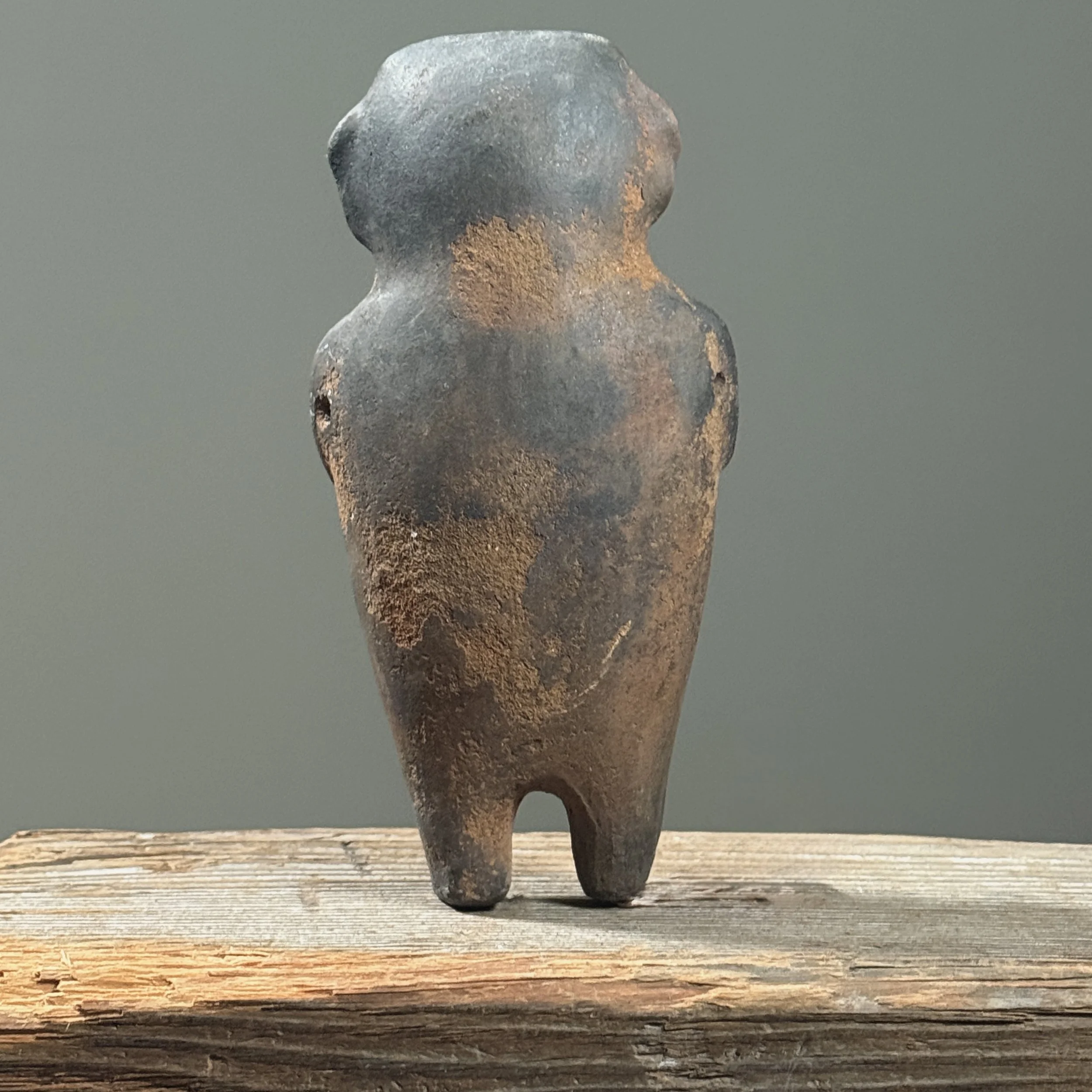 Pre-Columbian style figurative wood fired clay rattle. 7 inches height by 3.5 inches width by 2 inches depth.
