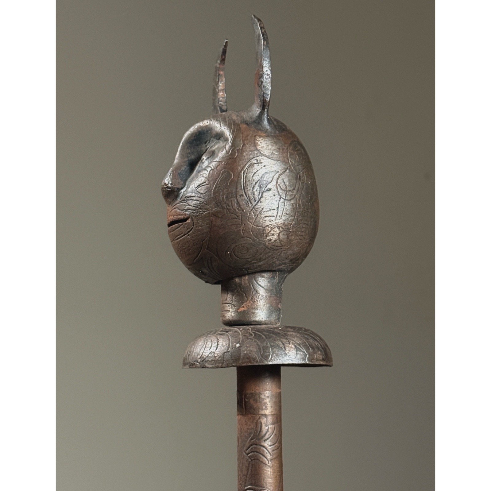 Side profile of devil mace showing hand-forged asymmetry of the demonic face.