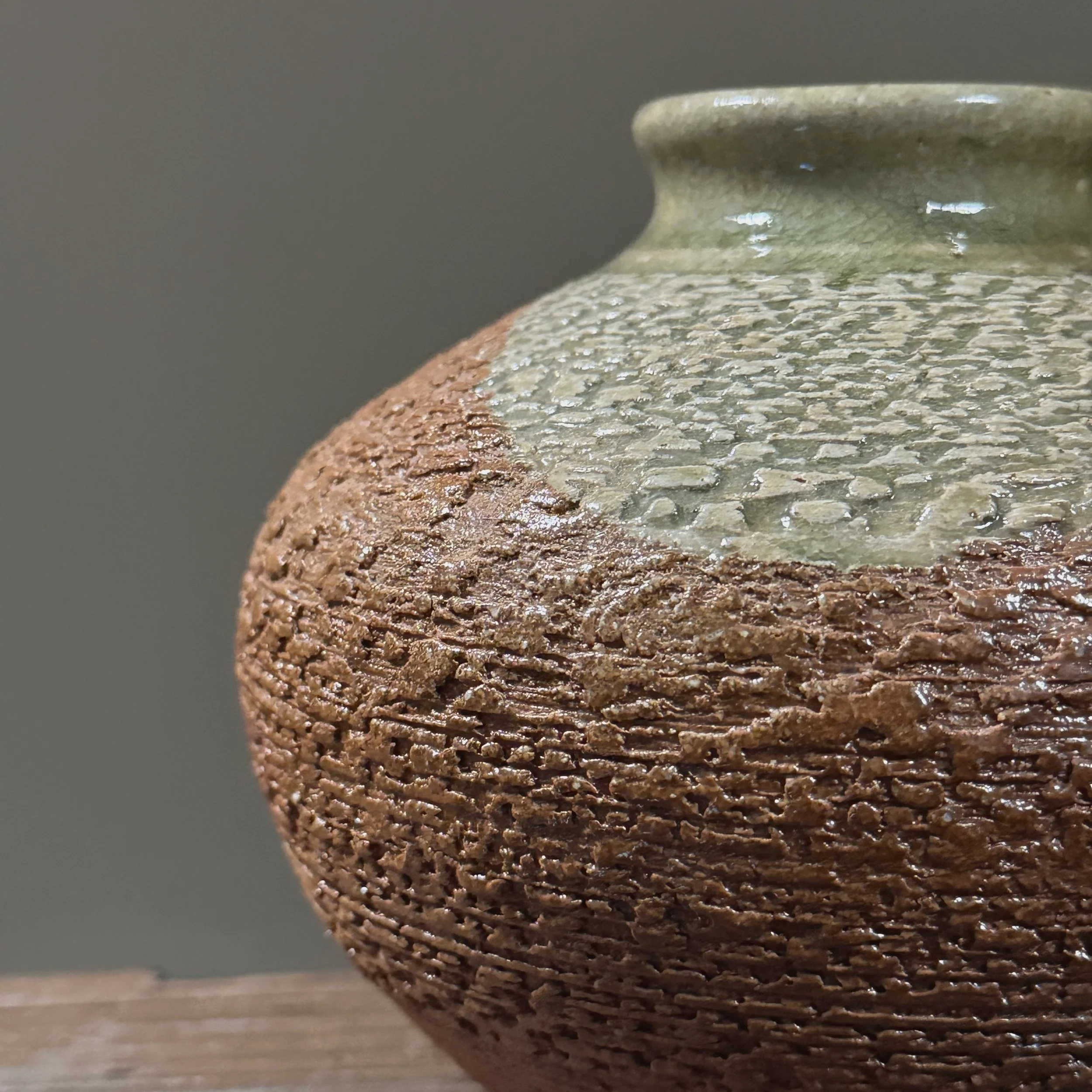 Detail of the vase's rim showing the celadon glaze drip on the exterior.