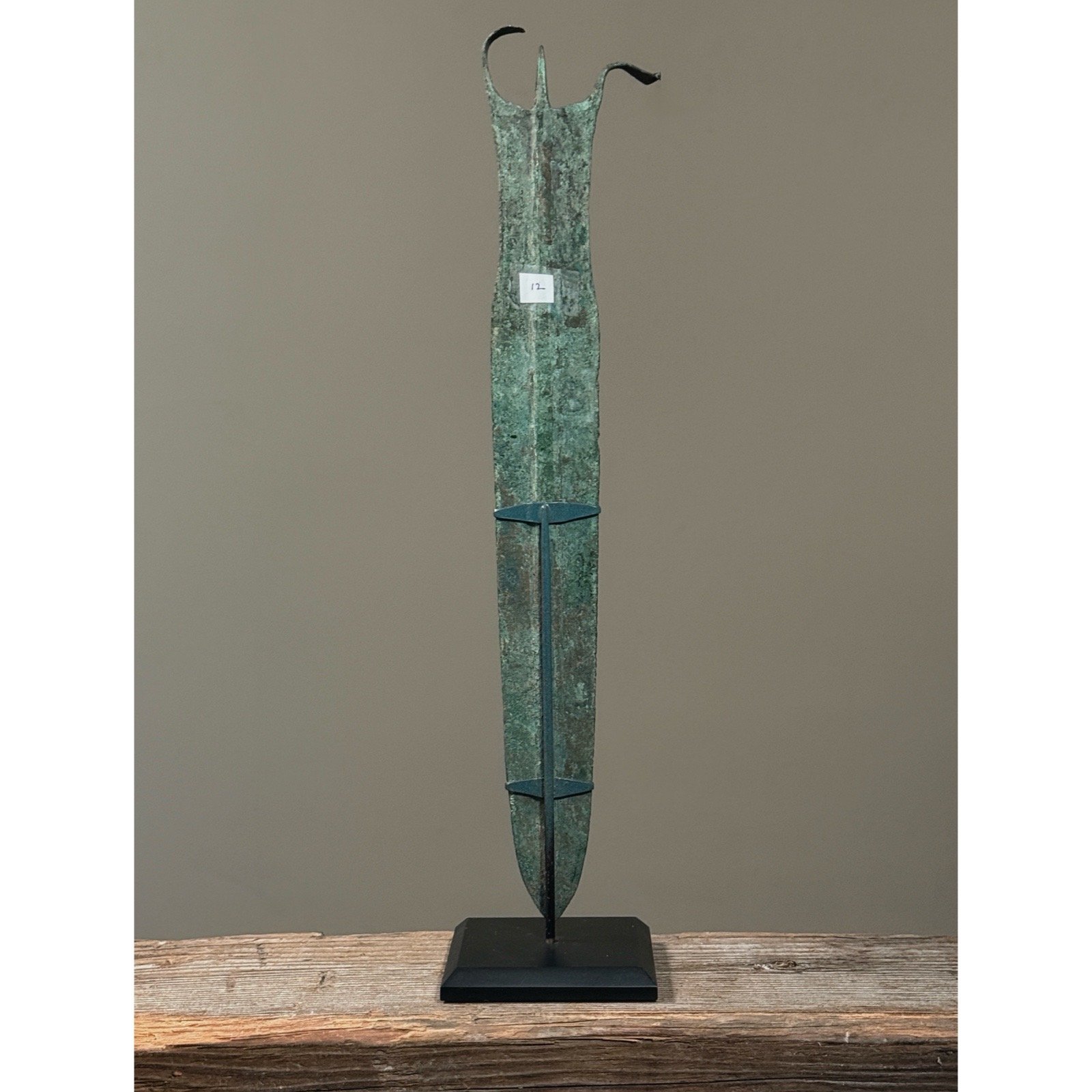 Back-facing view of the complete dagger artifact presented for display.