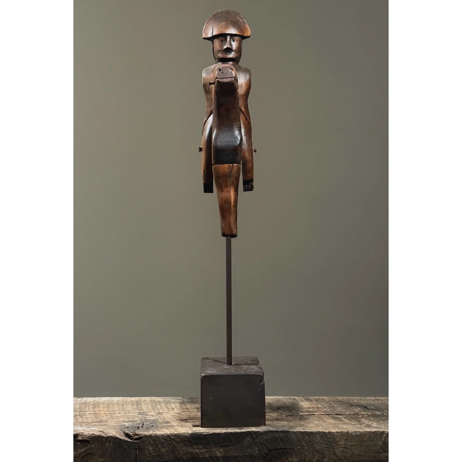 Vintage folk art hand-carved soldier on horse sculpture, full view.
