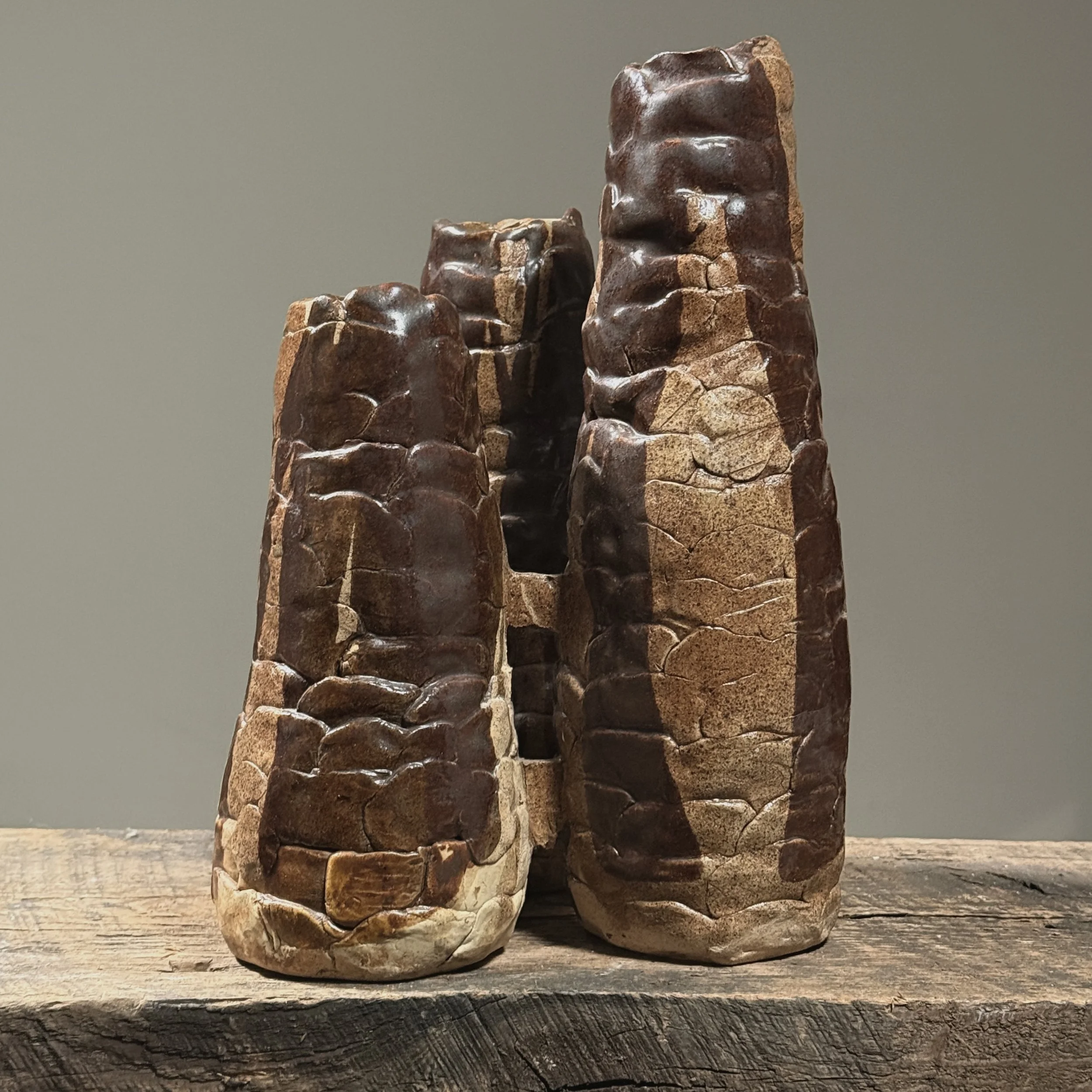 Full frontal view of a vintage Brutalist hand-built ceramic vessel with three connected cylindrical forms