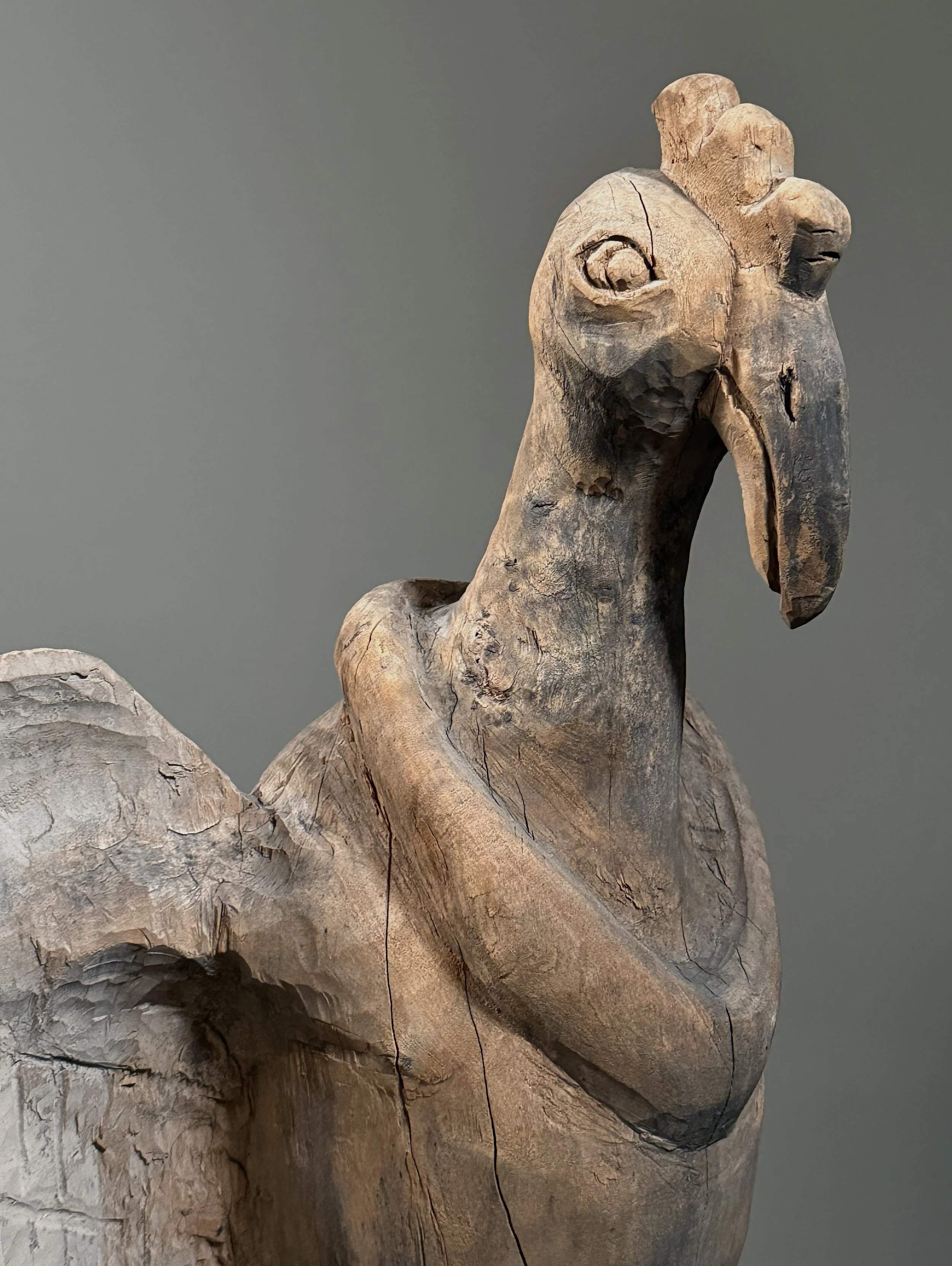 Folk art bird carving detail of head and beak