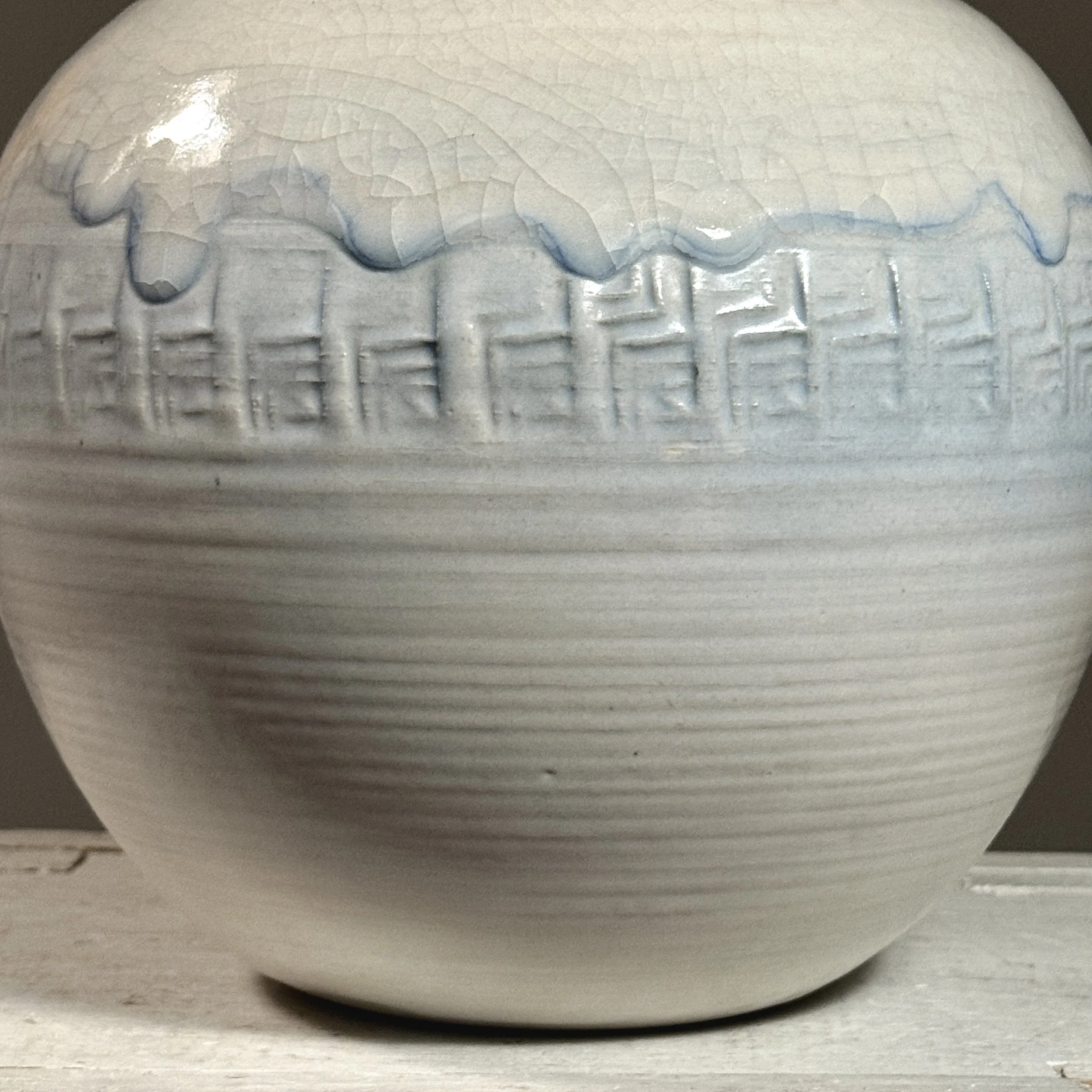 Detail of the crackle glaze pattern with faint blue undertone.
