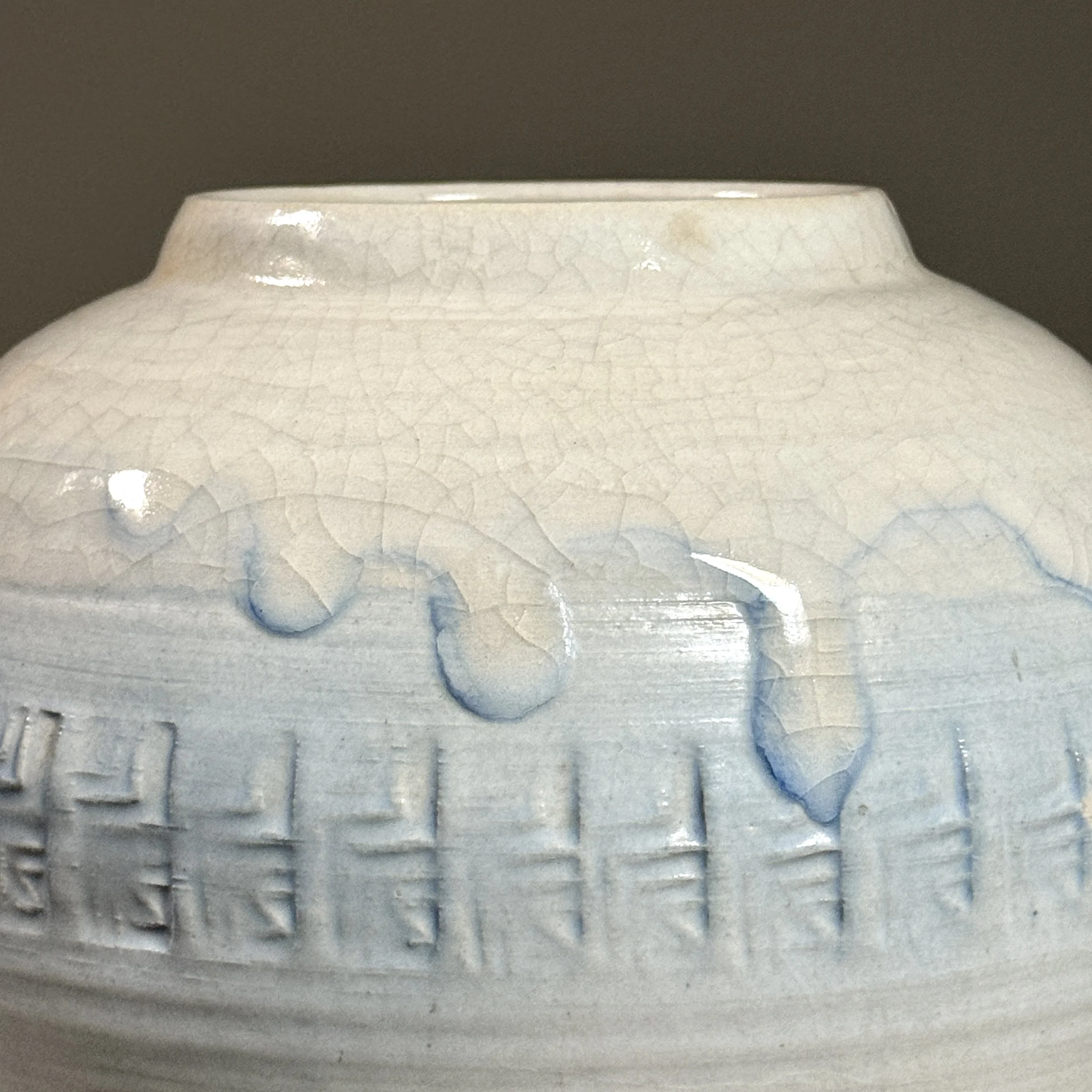 Detail of the crackle glaze pattern with faint blue undertone.