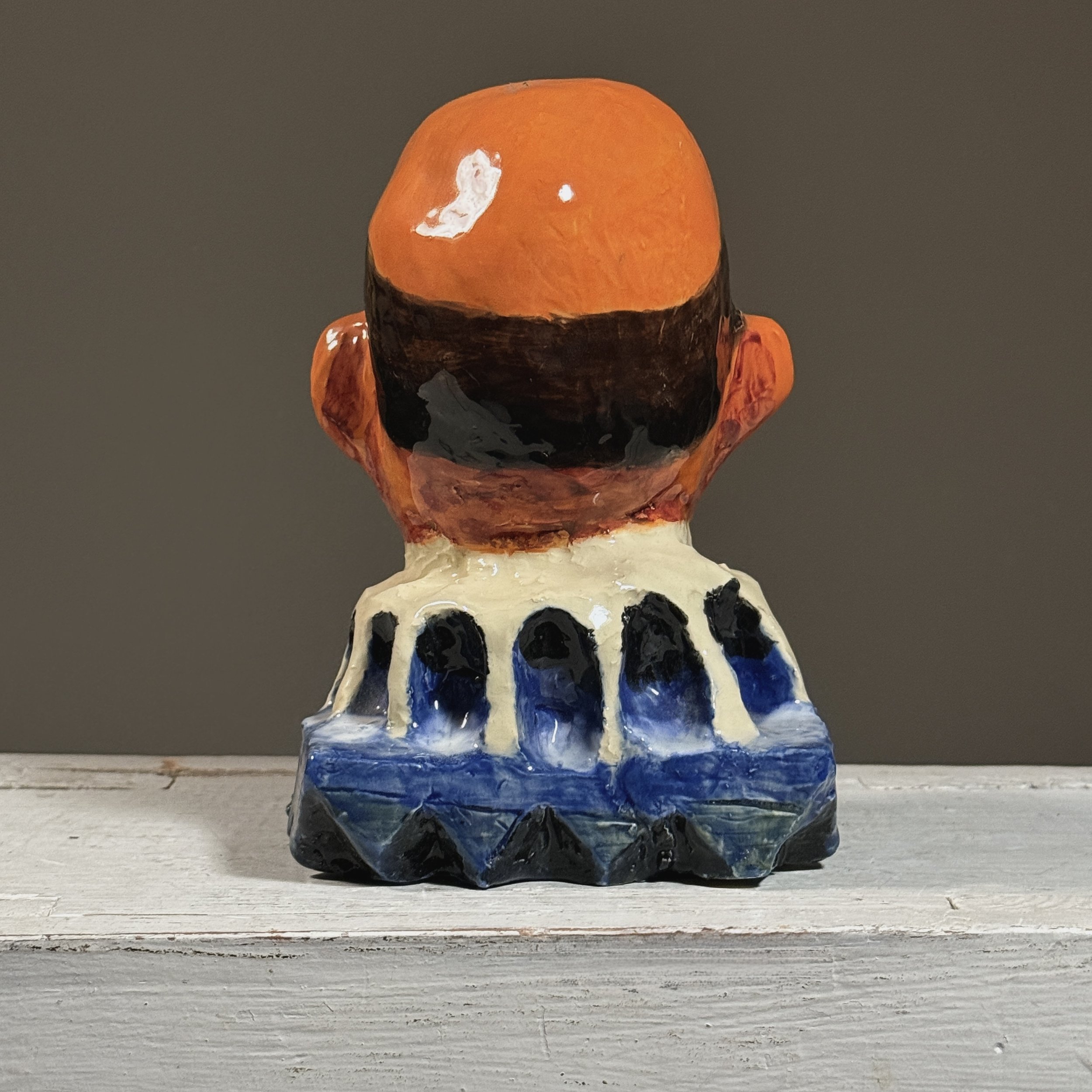 Rear view of a signed Gerber clown sculpture demonstrating hand-modeled plaster construction