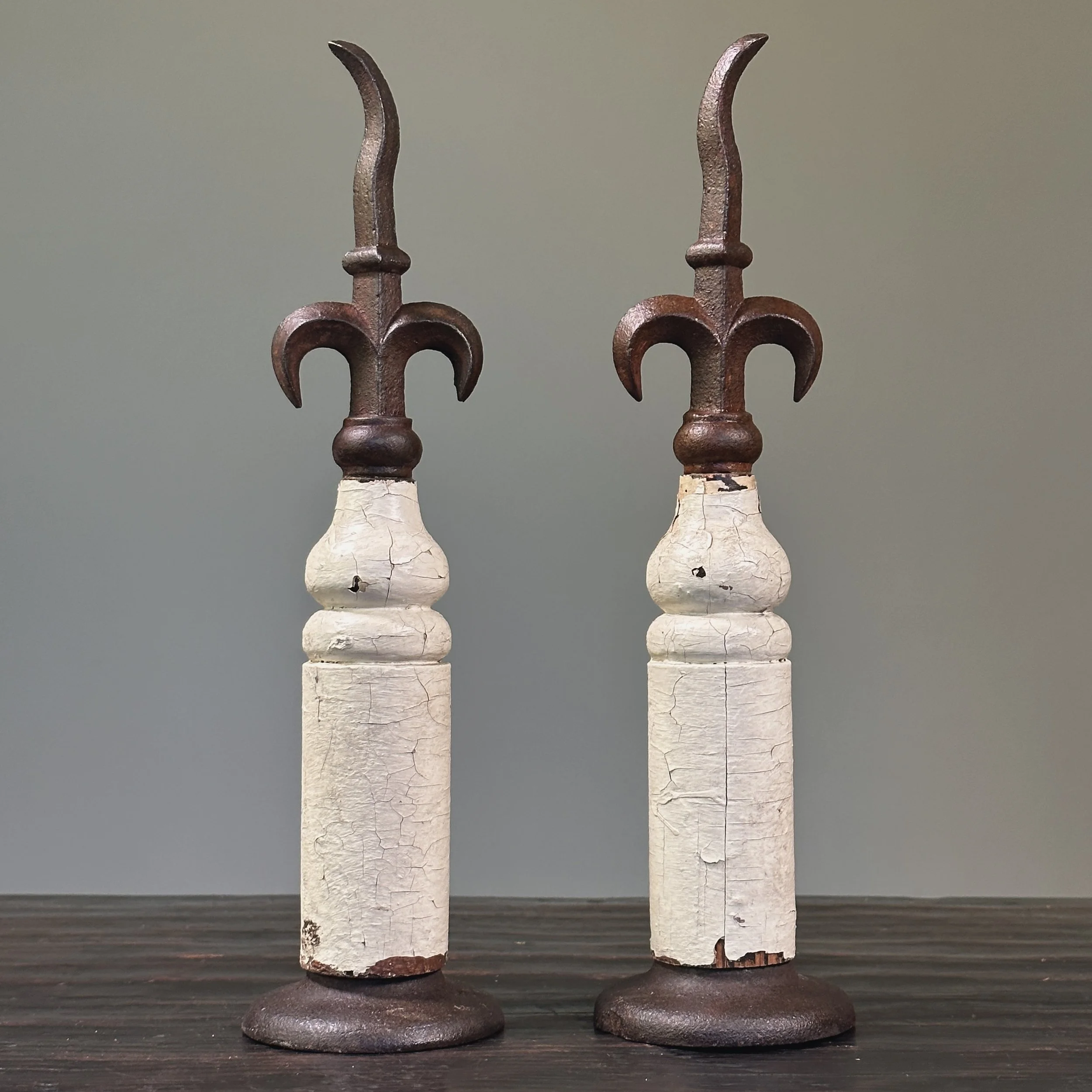 Pair of antique French fleur-de-lis cast iron finials on patinated wood bases