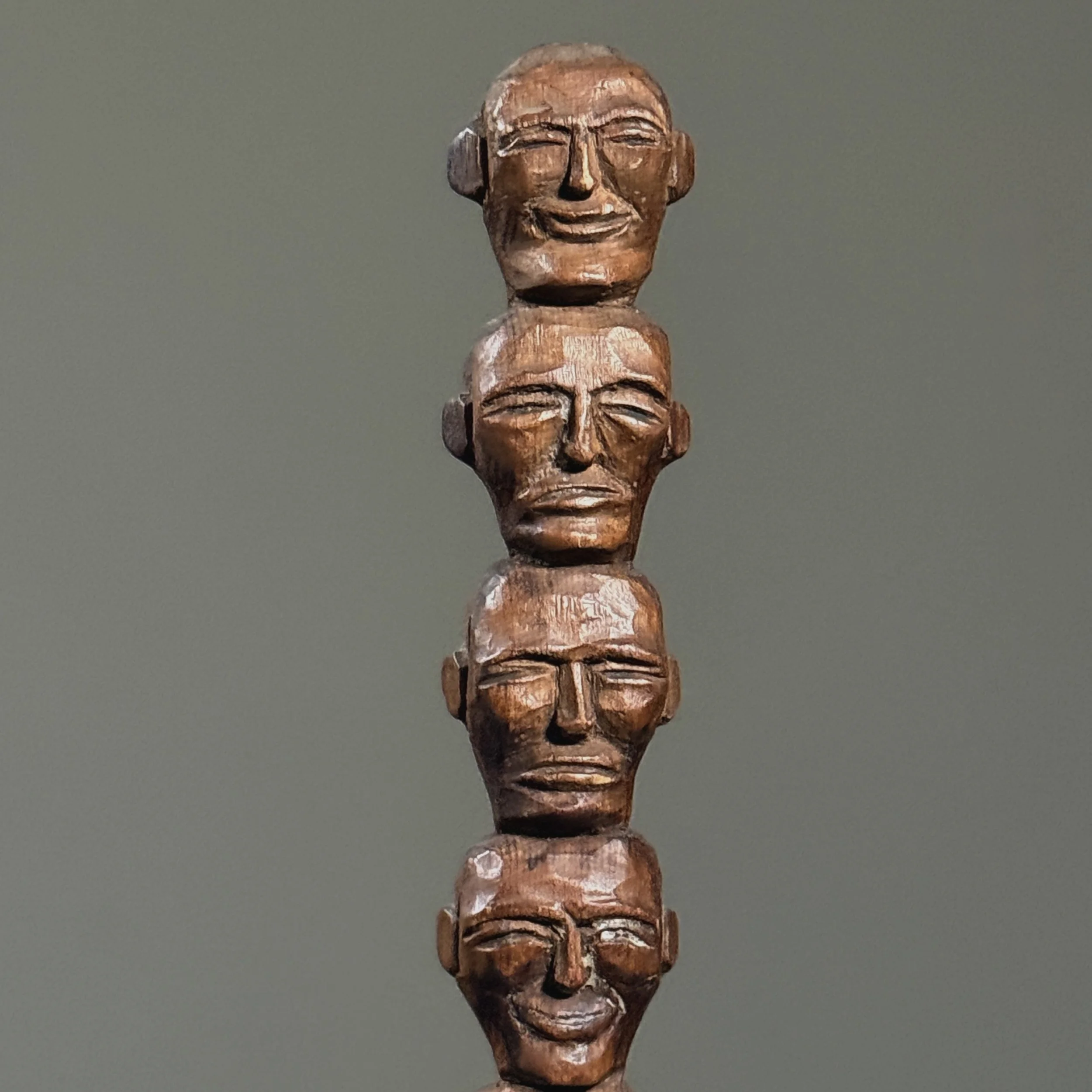 Close-up of carved folk art face on wooden totem