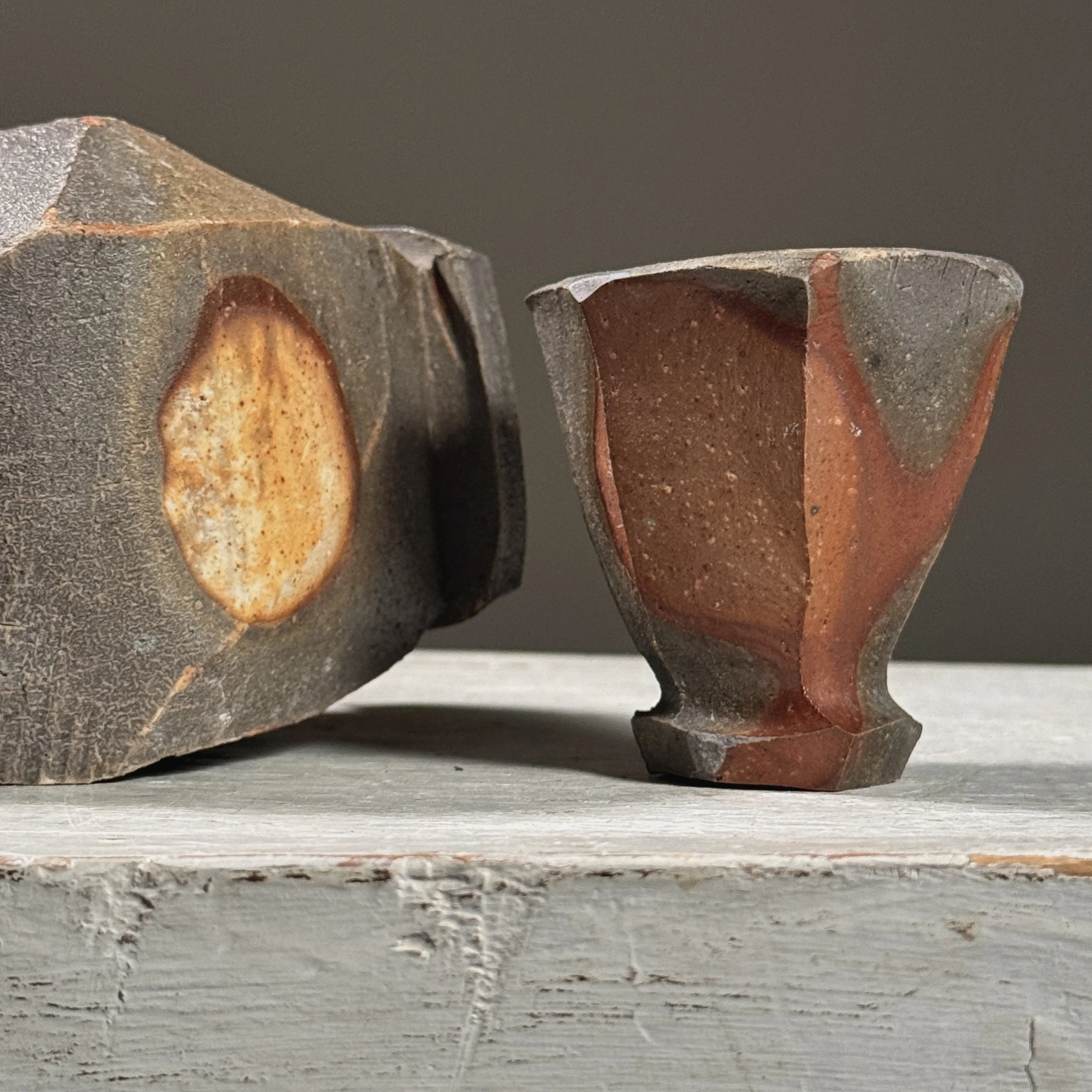 Detail of ash accumulation and kiln effects on stoneware surface.