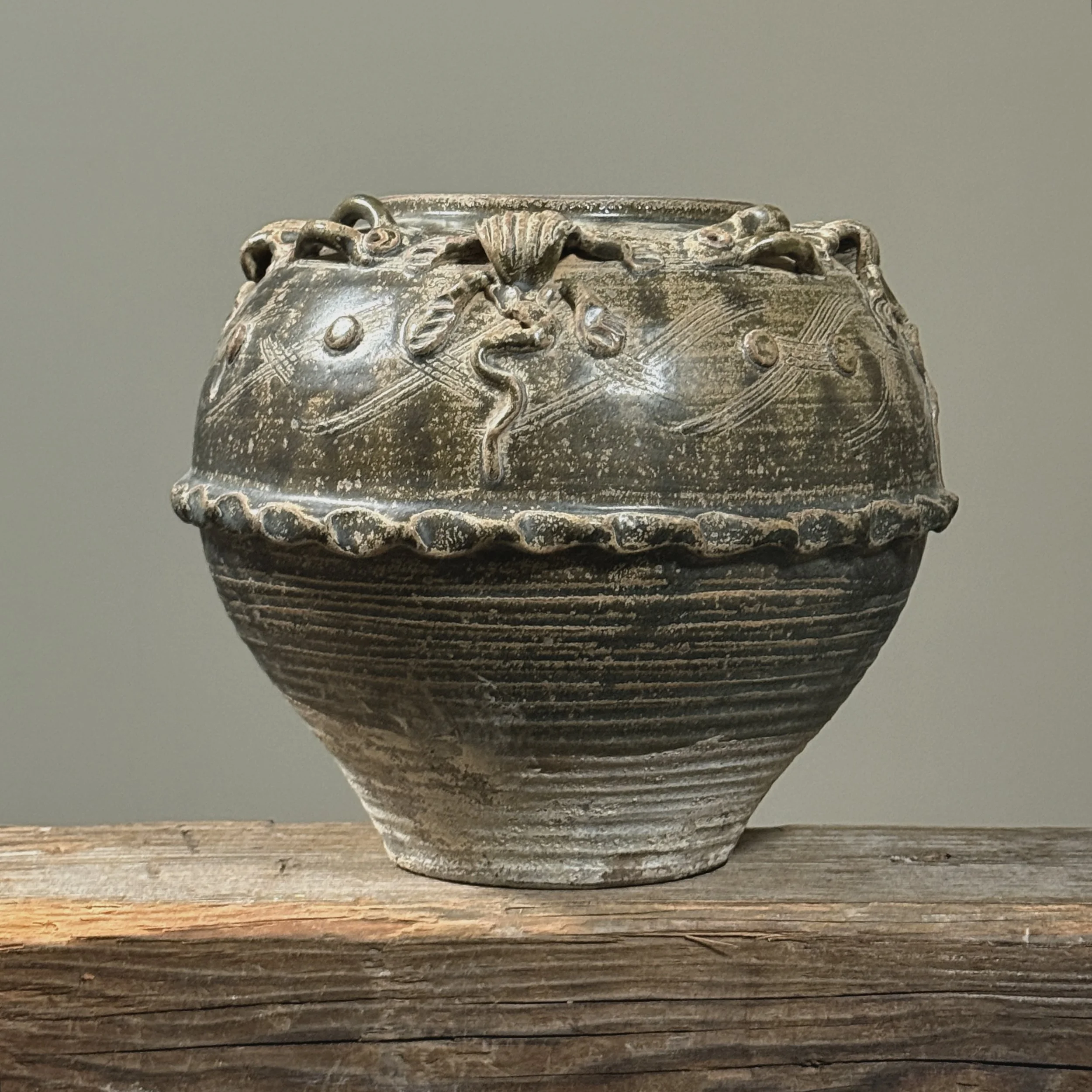 Front view of an antique 19th century Chinese brownish-green glazed stoneware vase.