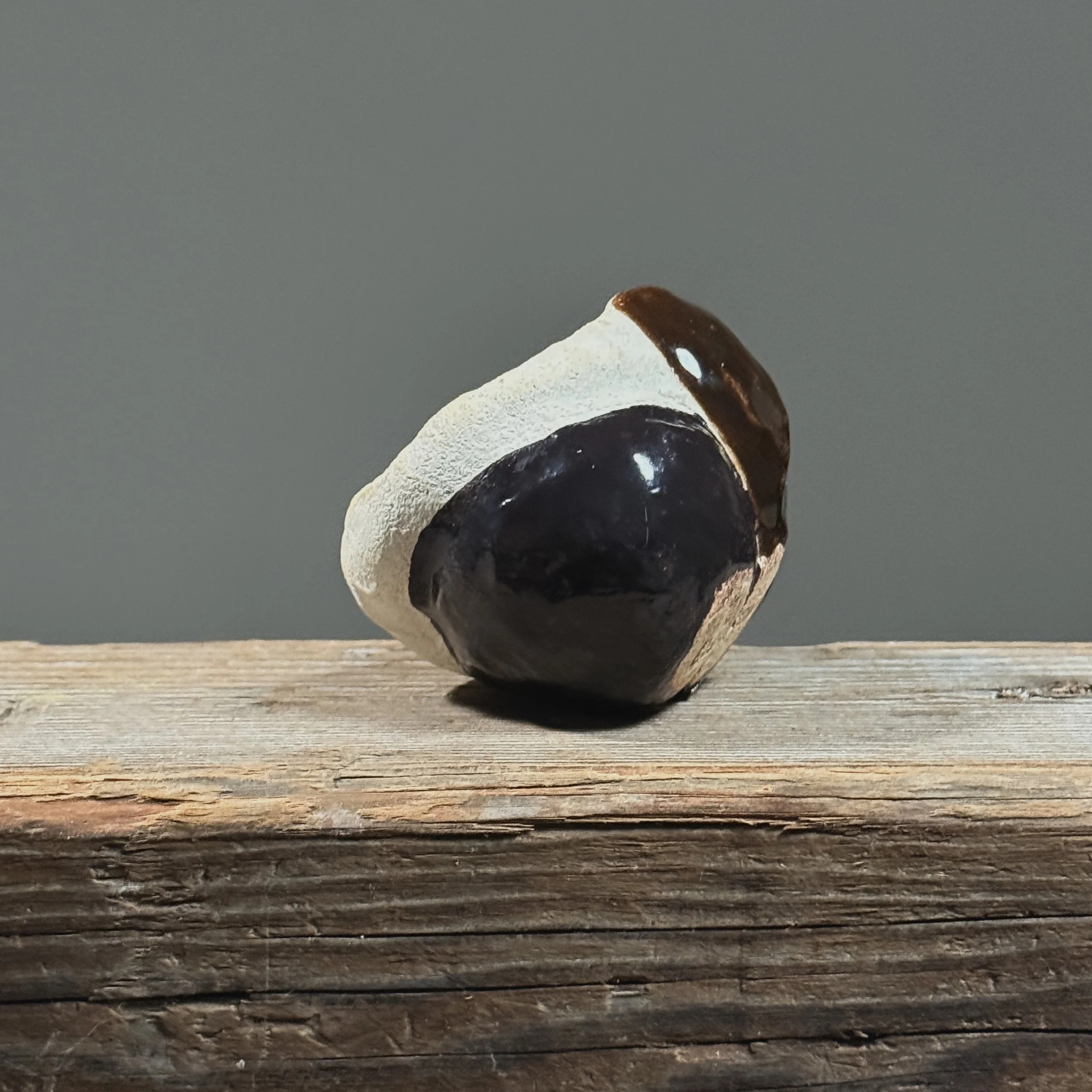 Glossy black vessel. Smooth finish. Modernist silhouette.