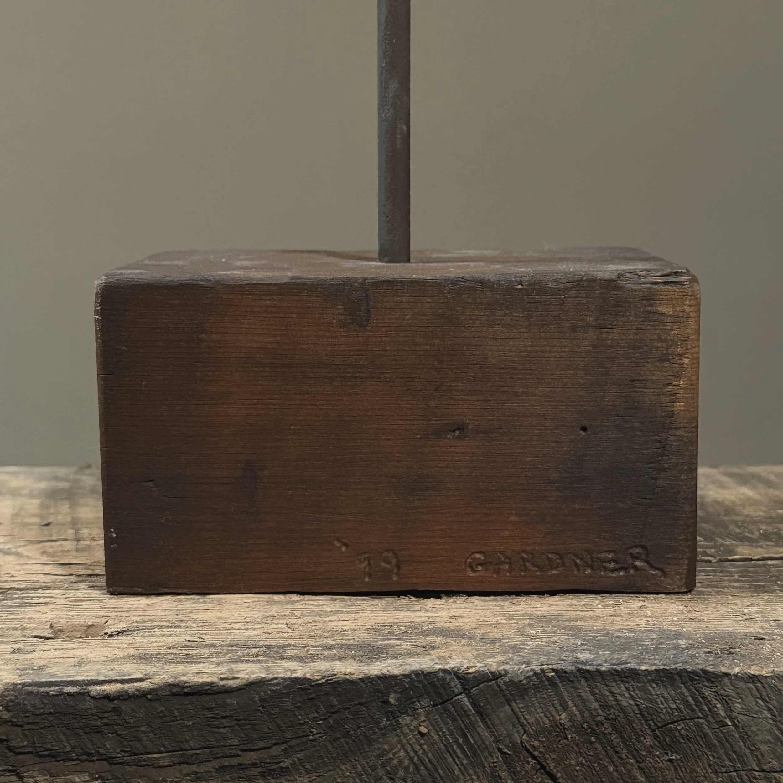 view showing the artist’s signature on back corner.