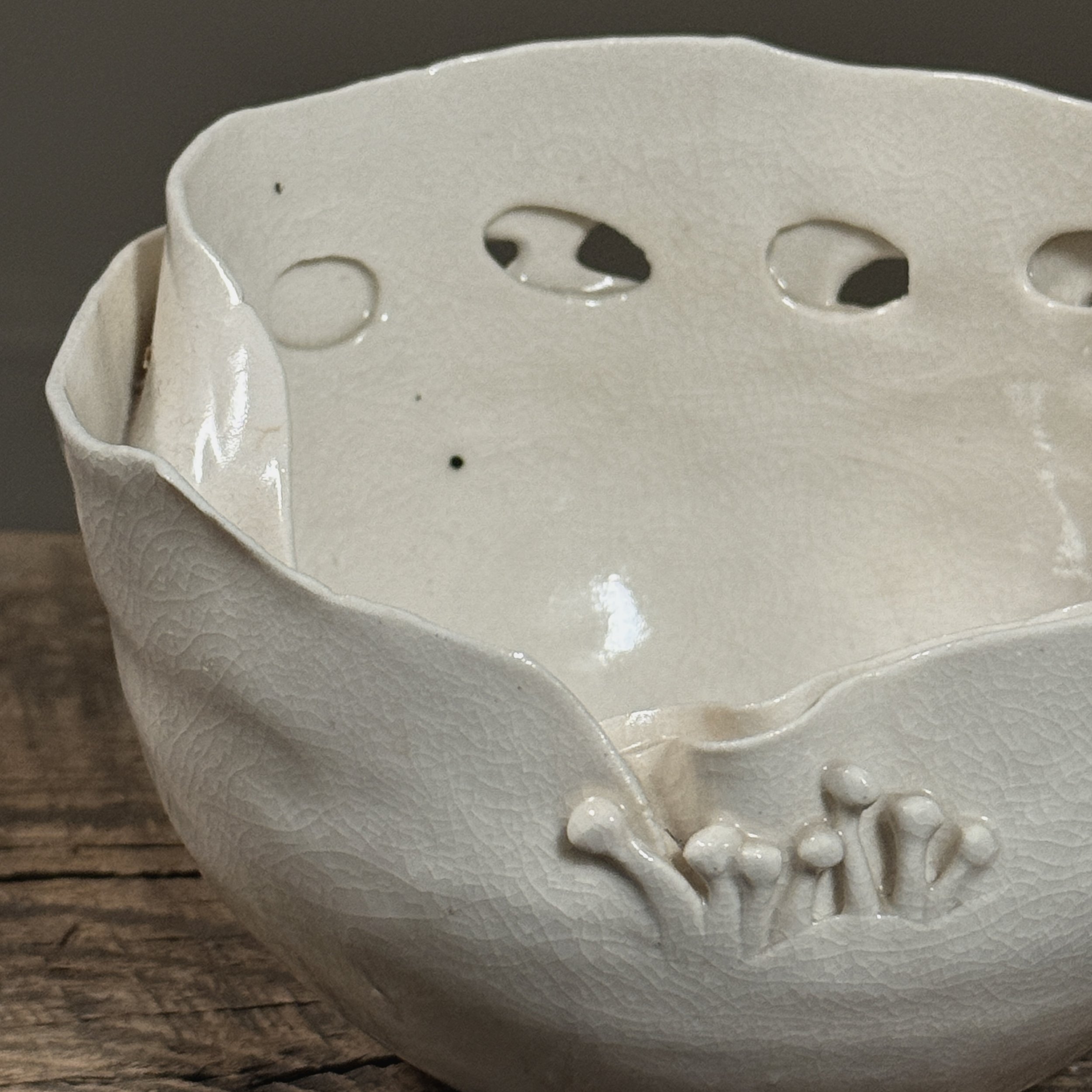 Close-up of spore-like sculptural detailing on vessel rim