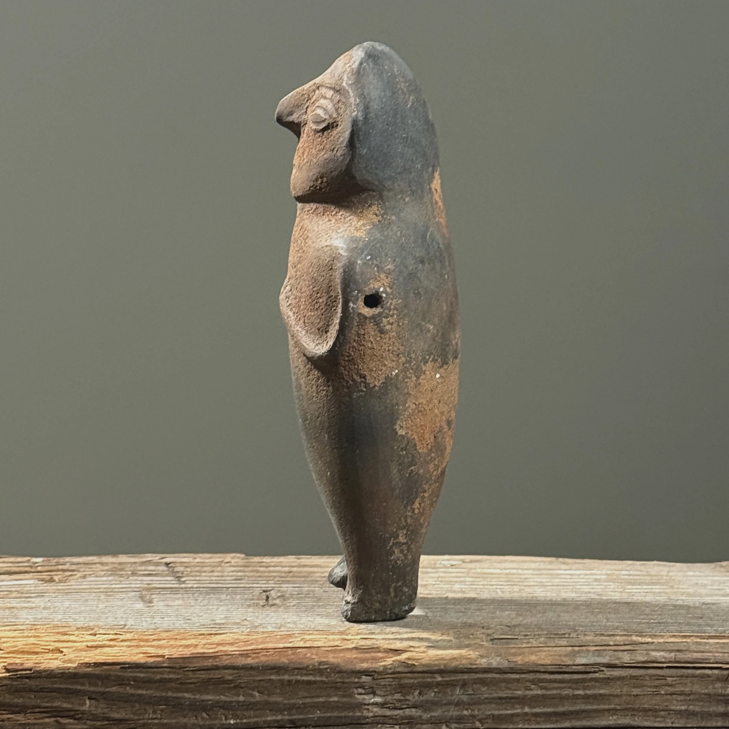 Pre-Columbian style figurative wood fired clay rattle. 7 inches height by 3.5 inches width by 2 inches depth.