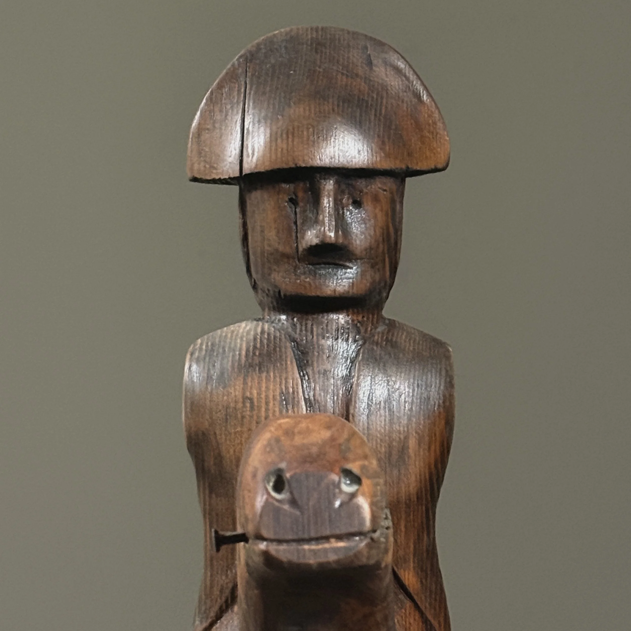 Close-up of soldier’s face and carved hat detail.
