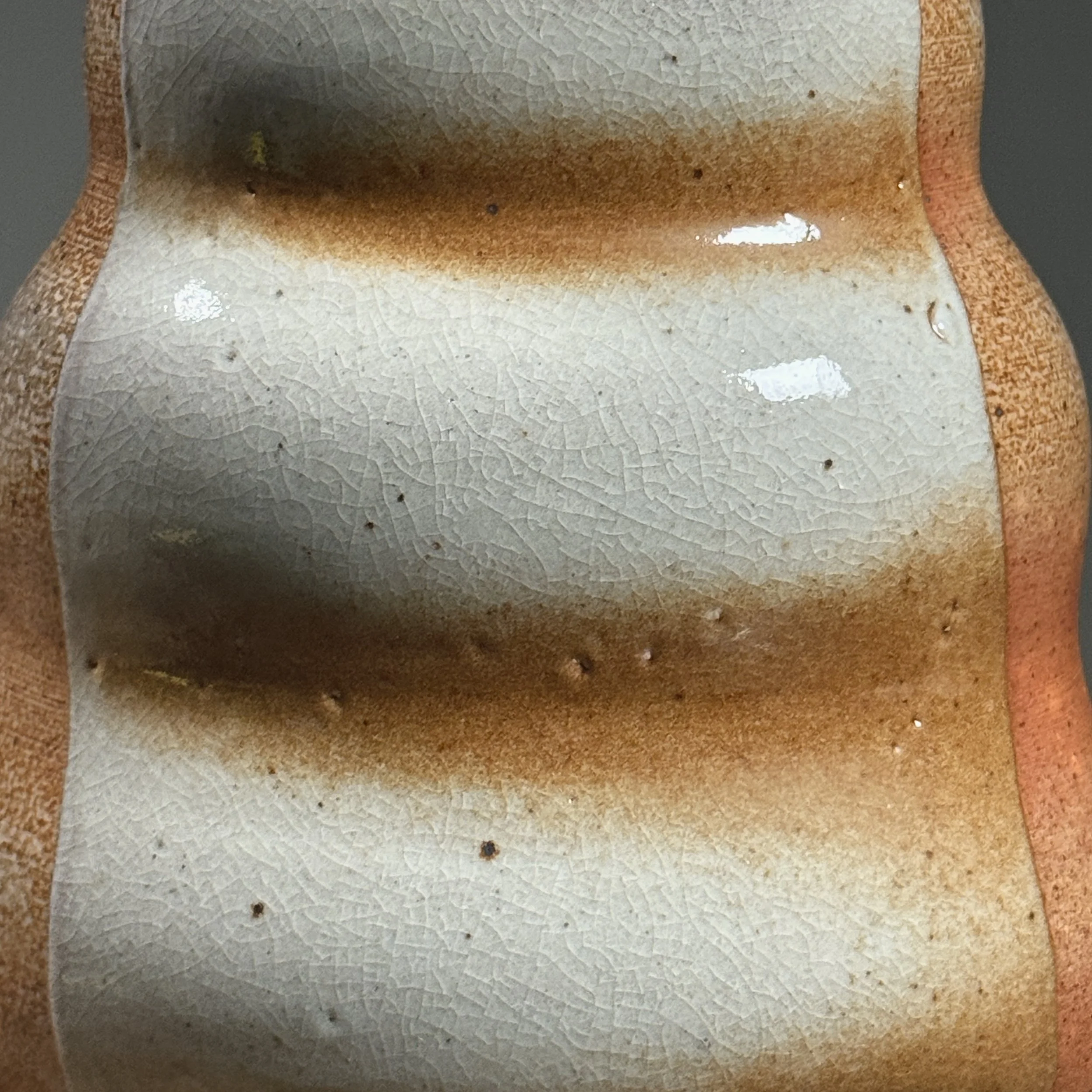 Close-up of the orange-peel texture characteristic of soda firing.