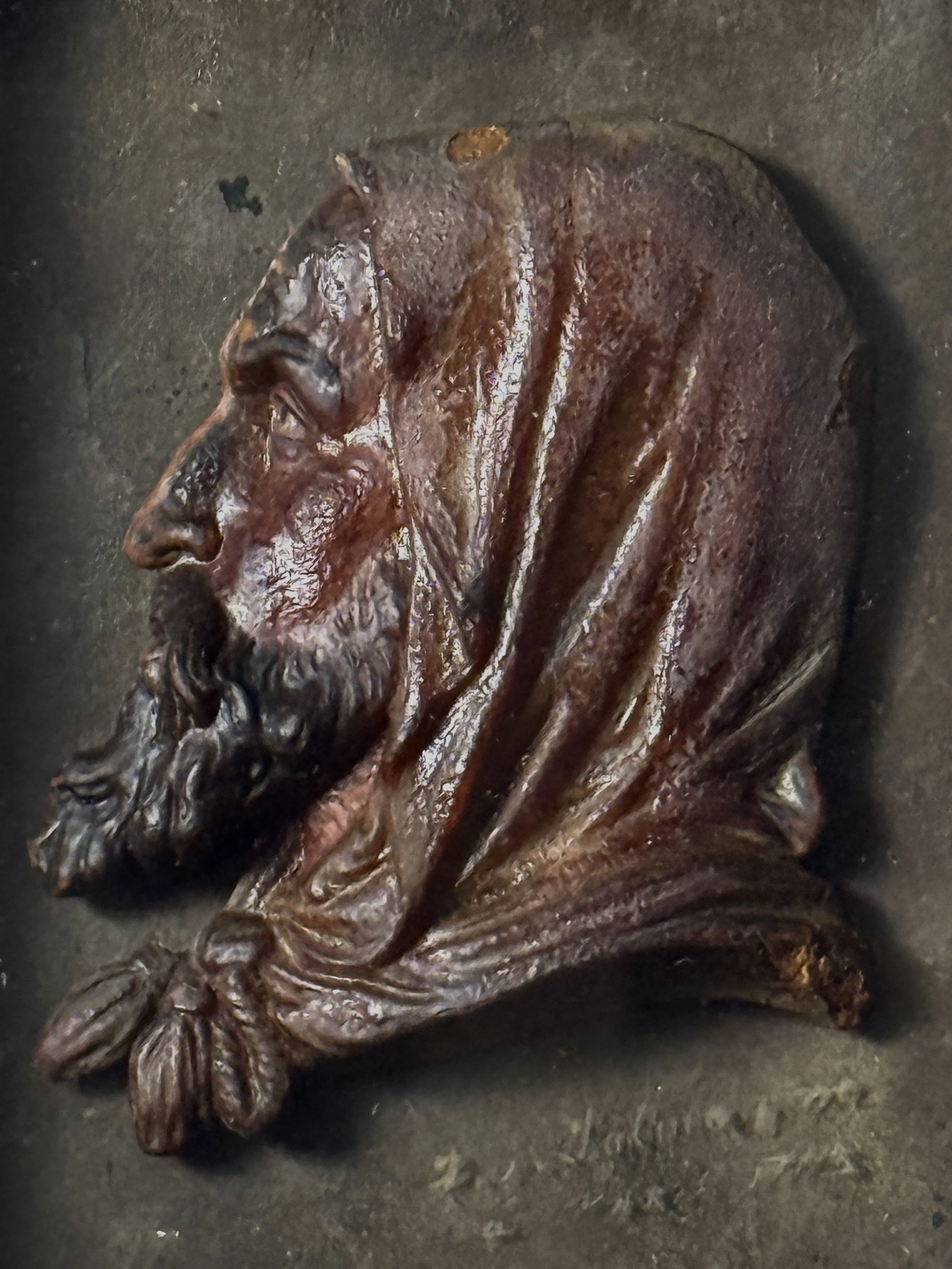Detail view of bearded man's face and hood in red wax bas-relief, antique French profile portrait, 1761