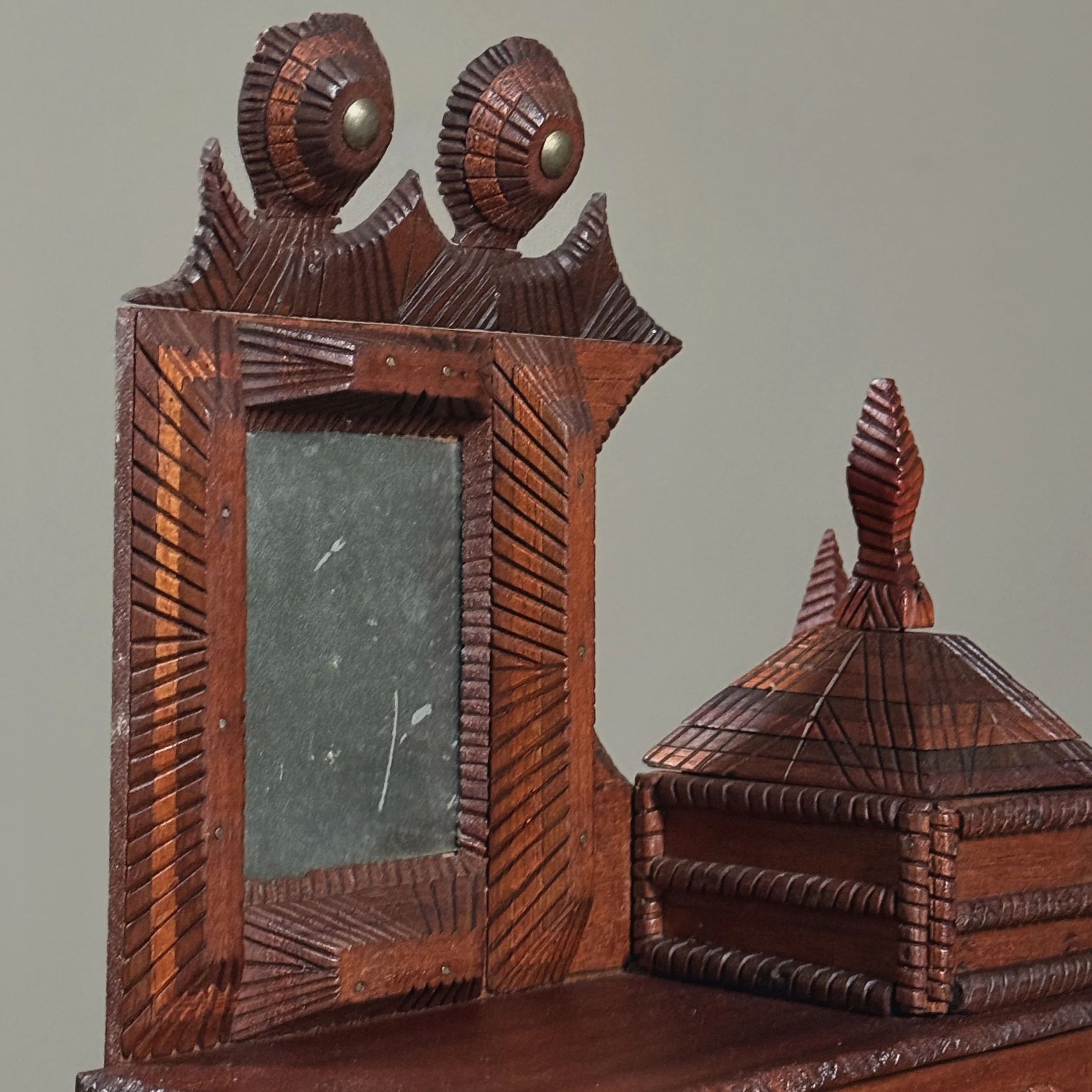 Detail of minor damage on carved round ornament above mirror