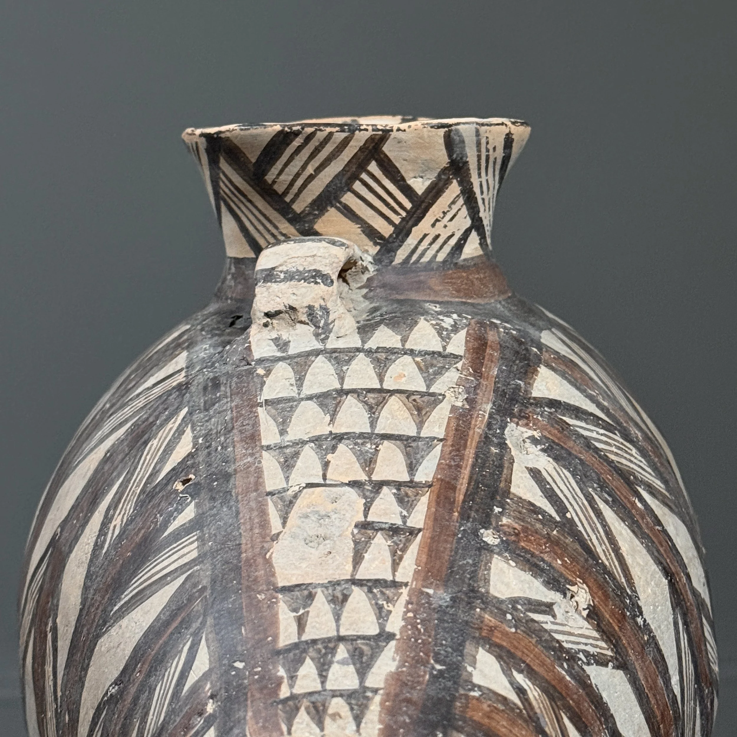 Detail of surface wear and paint loss on pottery