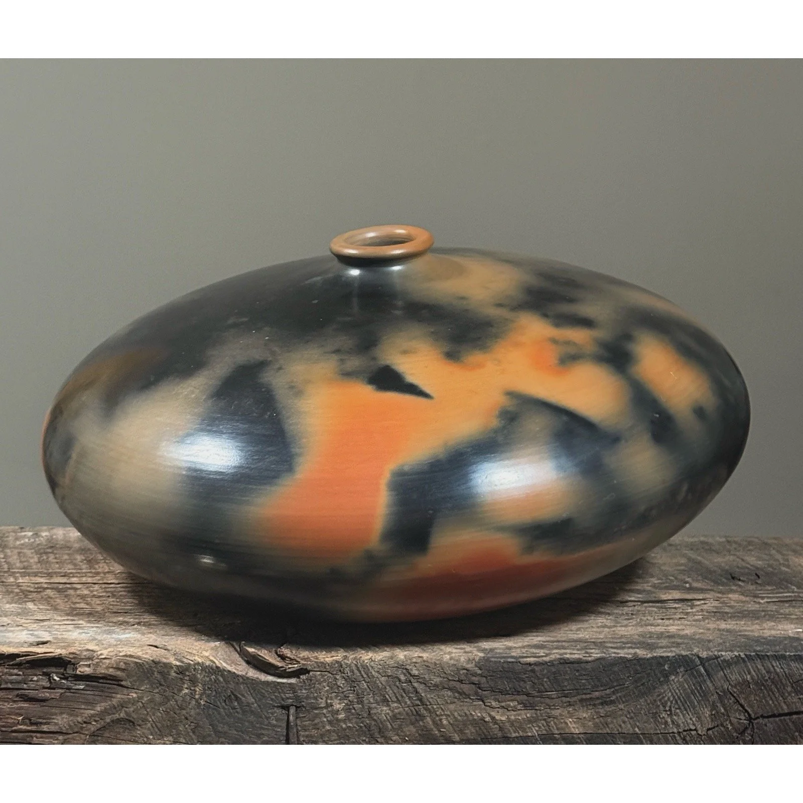 Large hand-turned burnished seed pot with rounded form and stout neck.